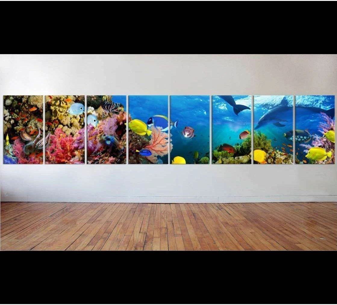 Panoramic tropical reef canvas print with colorful fish and coral displayed on a wide wall