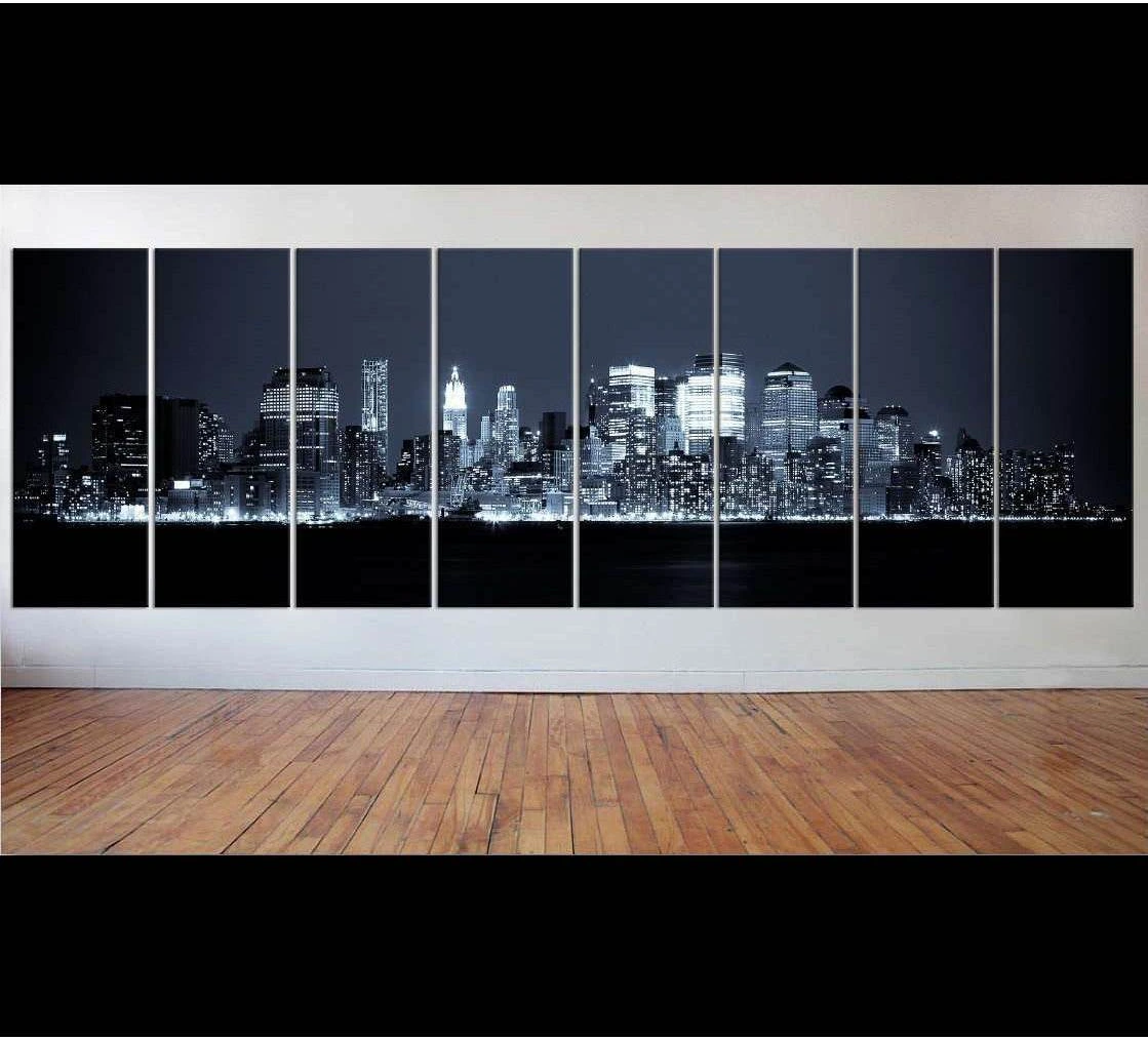 Black and white NYC skyline panoramic canvas print displayed as multi-panel wall art in a modern room