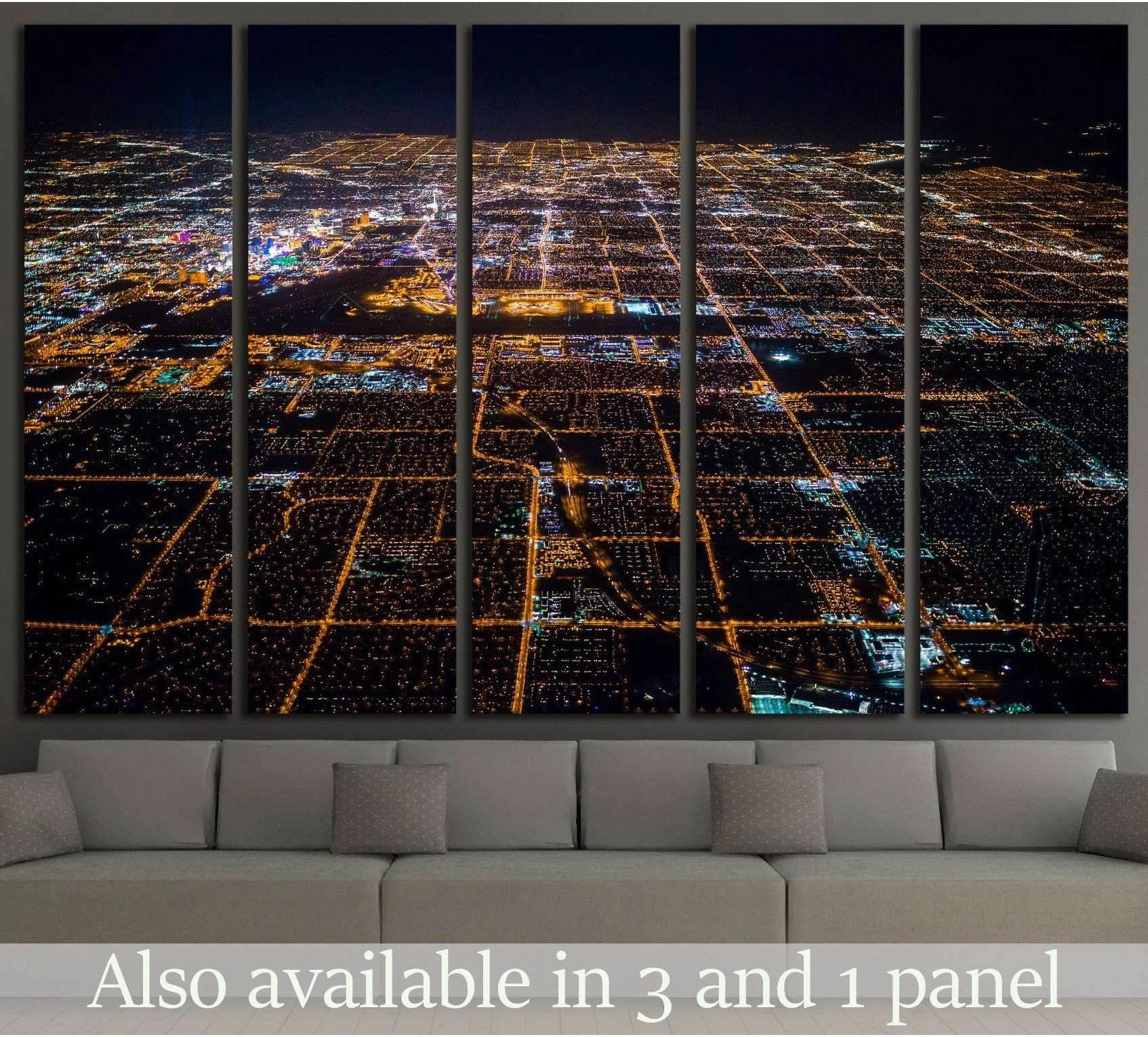 Las Vegas aerial canvas print with glowing Strip and desert grid at night above a sofa