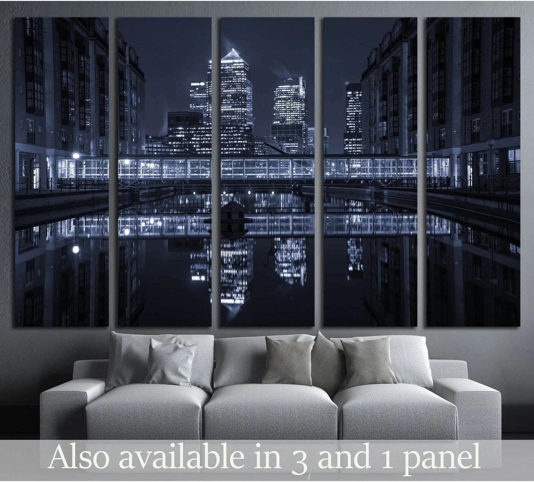 Canary Wharf London skyline canvas print with night reflections above a sofa in a modern living room