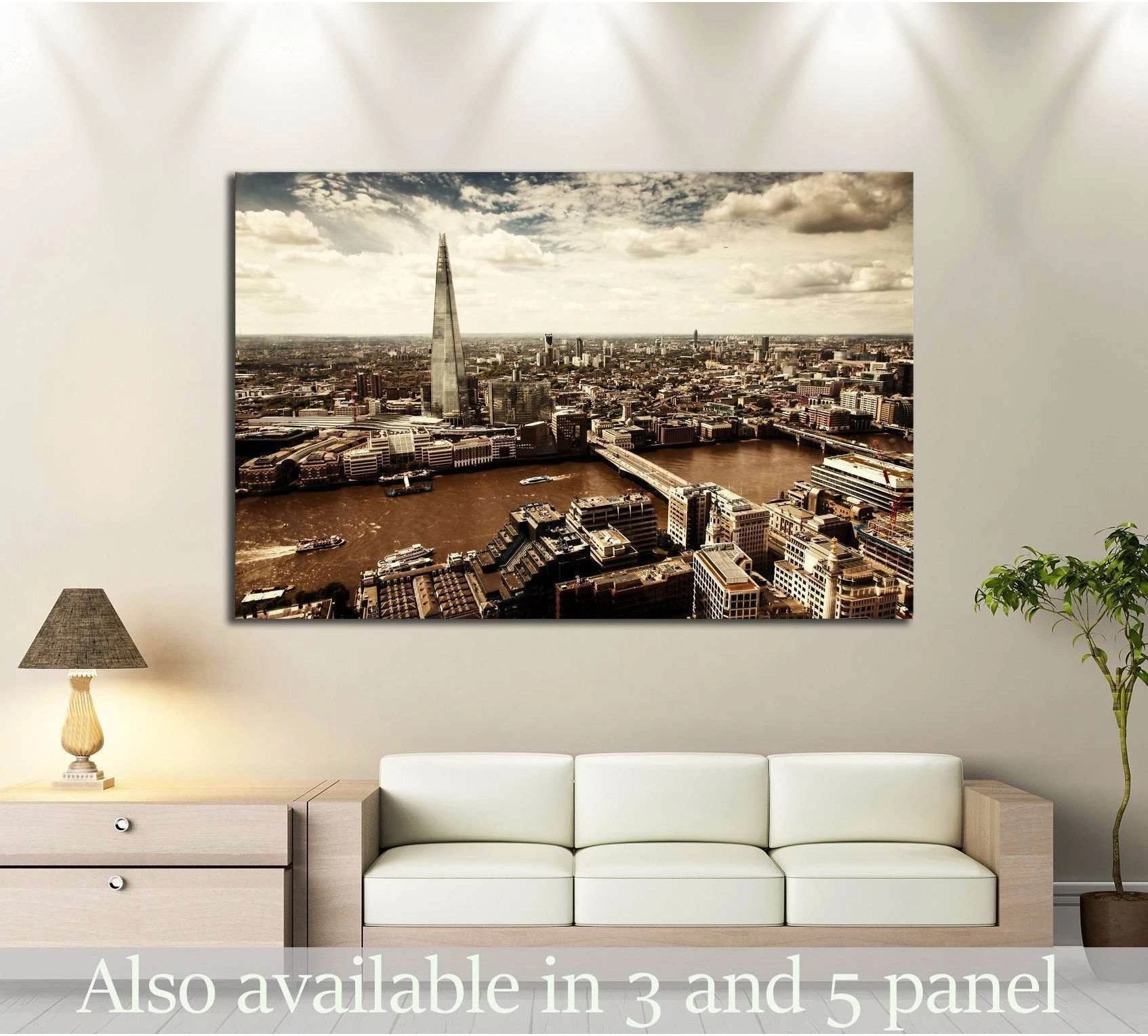 London aerial view canvas print with The Shard and River Thames above a sofa in a modern living room