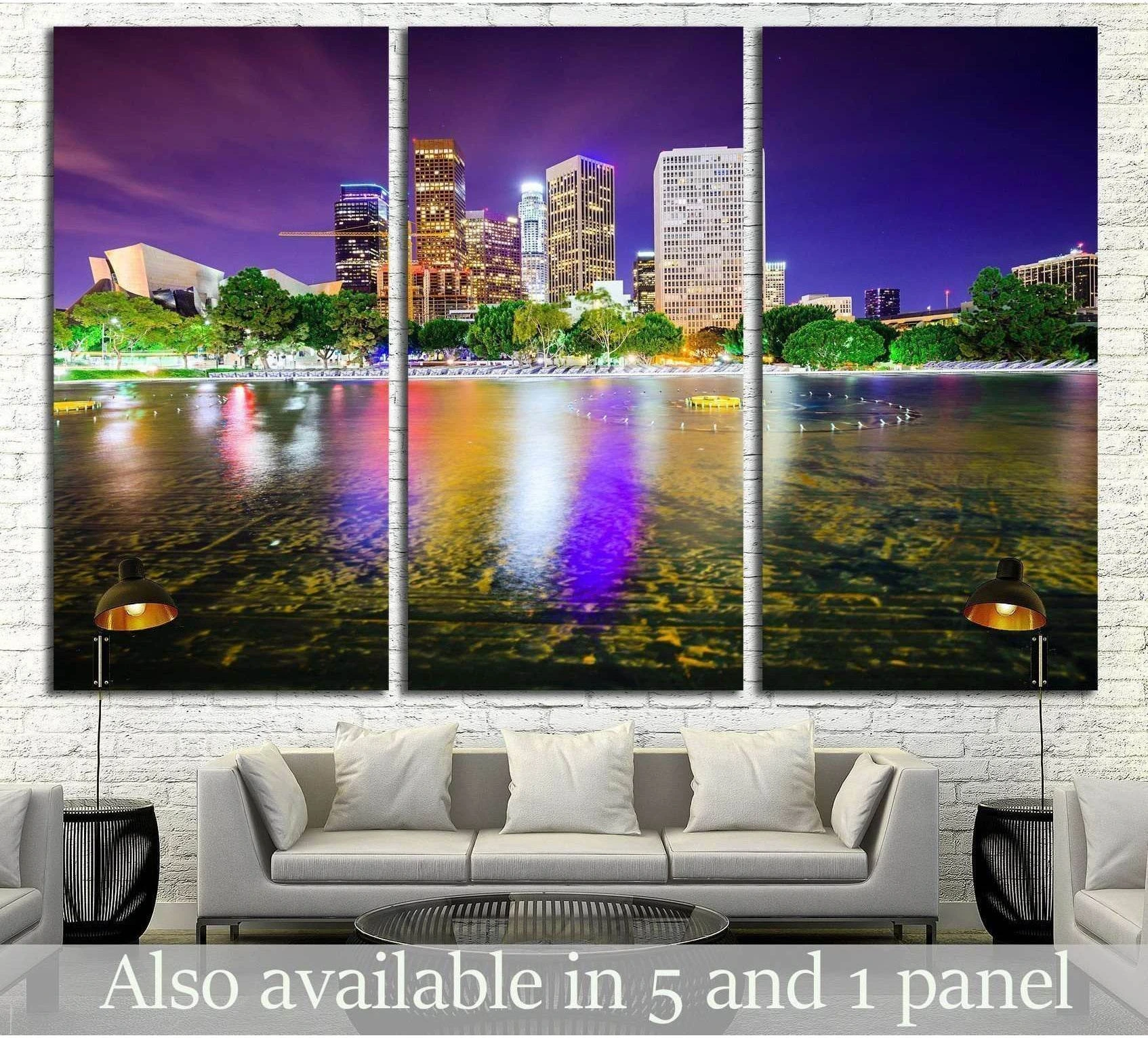 Los Angeles skyline triptych canvas print with purple night sky and colorful water reflections above a sofa
