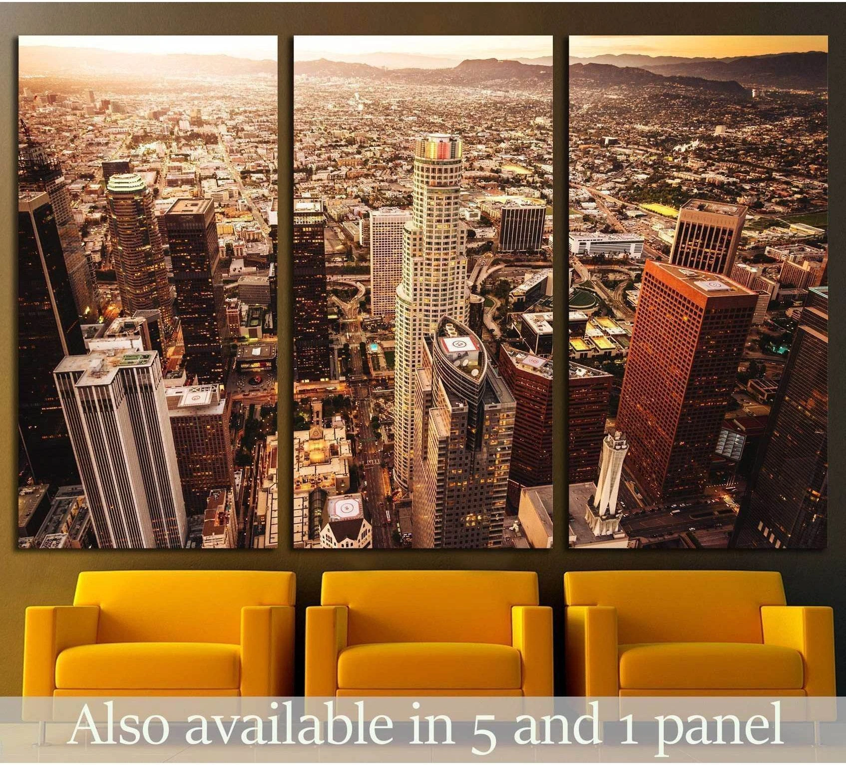 Los Angeles skyline aerial view triptych canvas print above mustard chairs in a modern living room