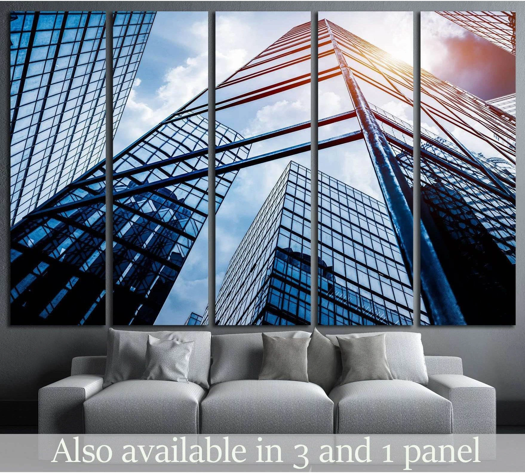 Low-angle skyscraper canvas print with blue glass towers above a sofa in a modern room