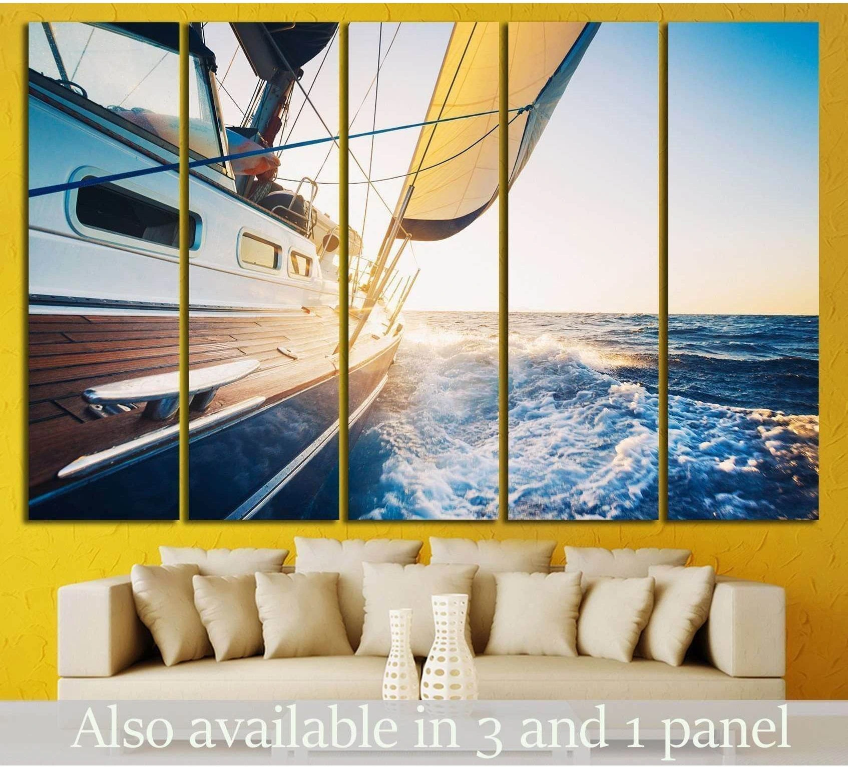 Luxury yacht canvas print with sunlit sails and ocean spray, displayed above a sofa in a coastal living room