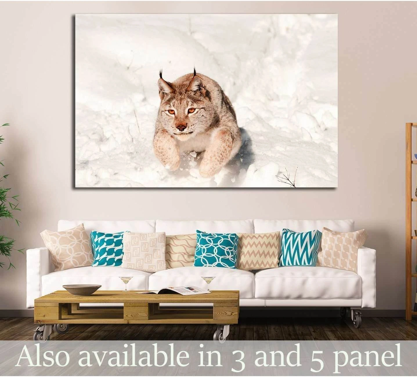 Lynx jumping through fresh snow canvas print hung above a sofa in a neutral living room