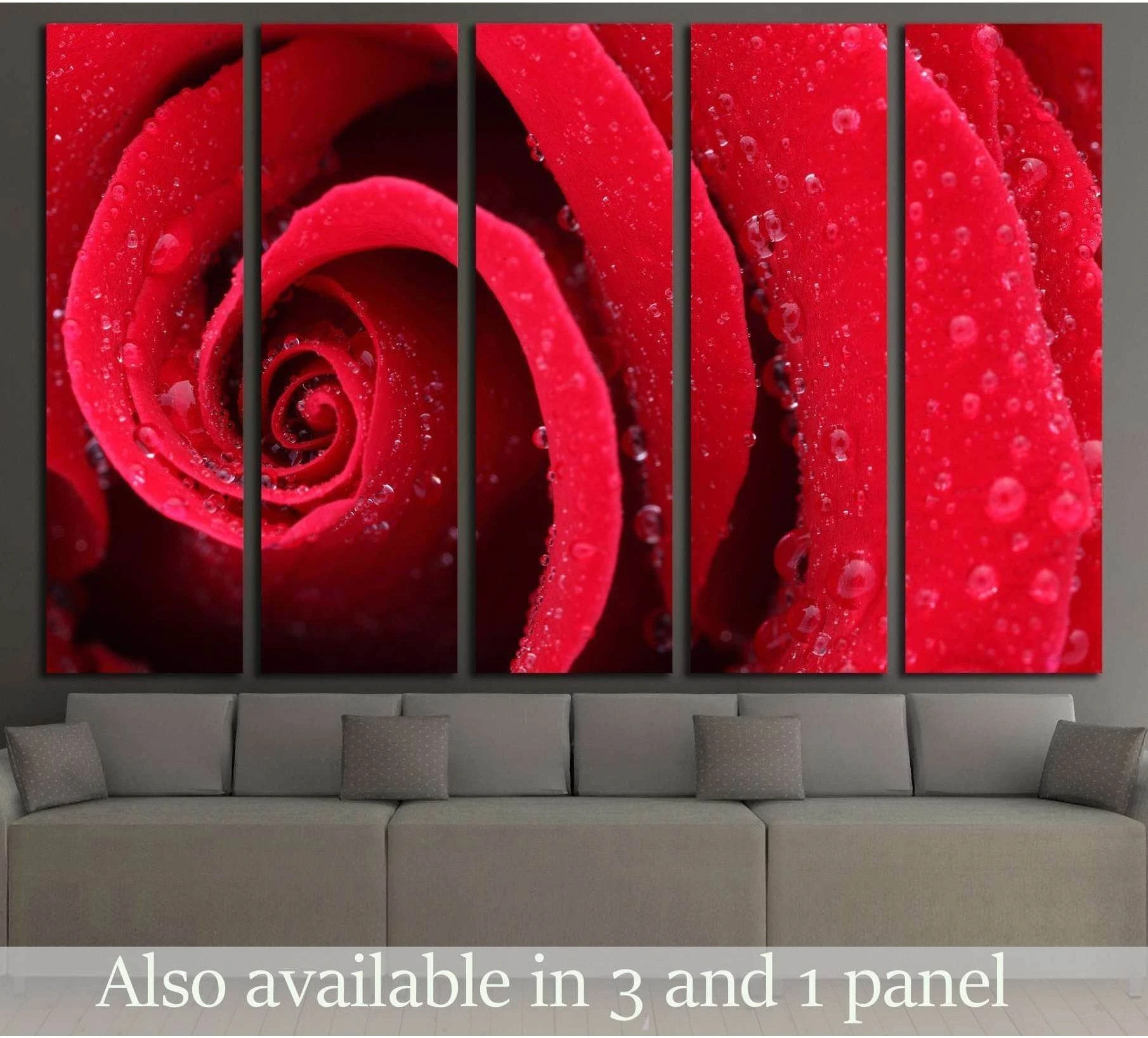 Macro red rose canvas print with dewdrops displayed above a sofa in a modern living room