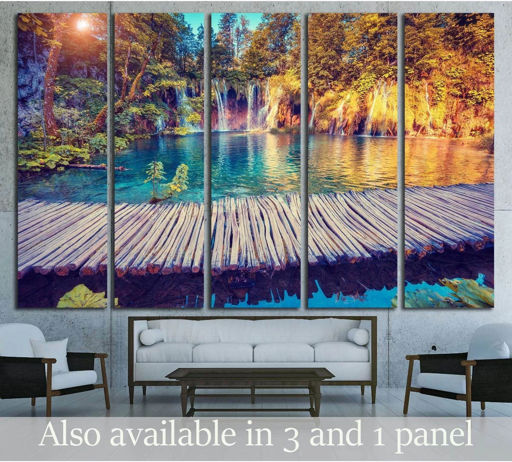 Plitvice Lakes waterfall canvas print with turquoise lake, wooden boardwalk, and sunlit forest in a multi-panel living room display