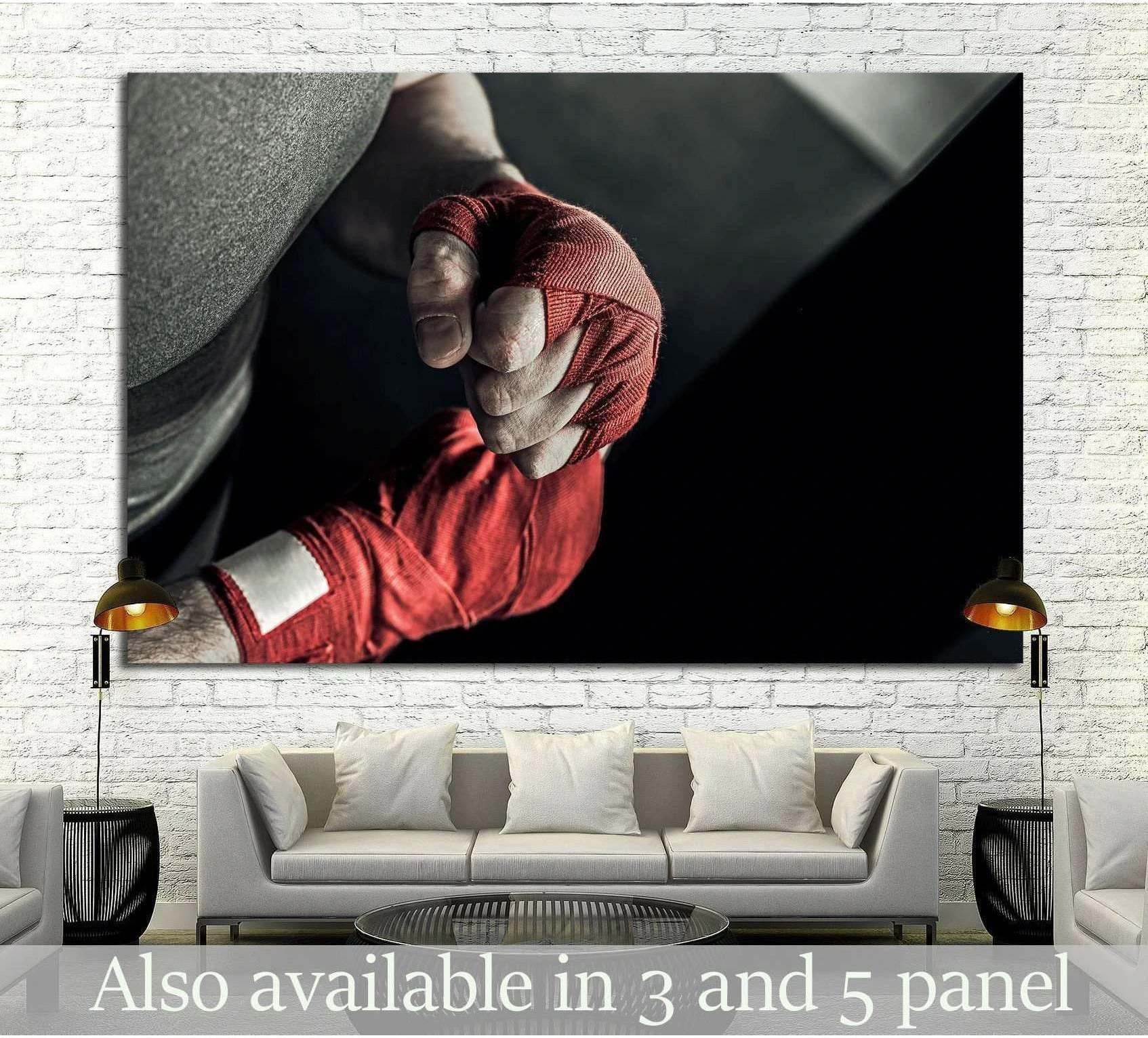 Boxing hand wraps canvas print with a close-up red-wrapped fist above a sofa in a modern room