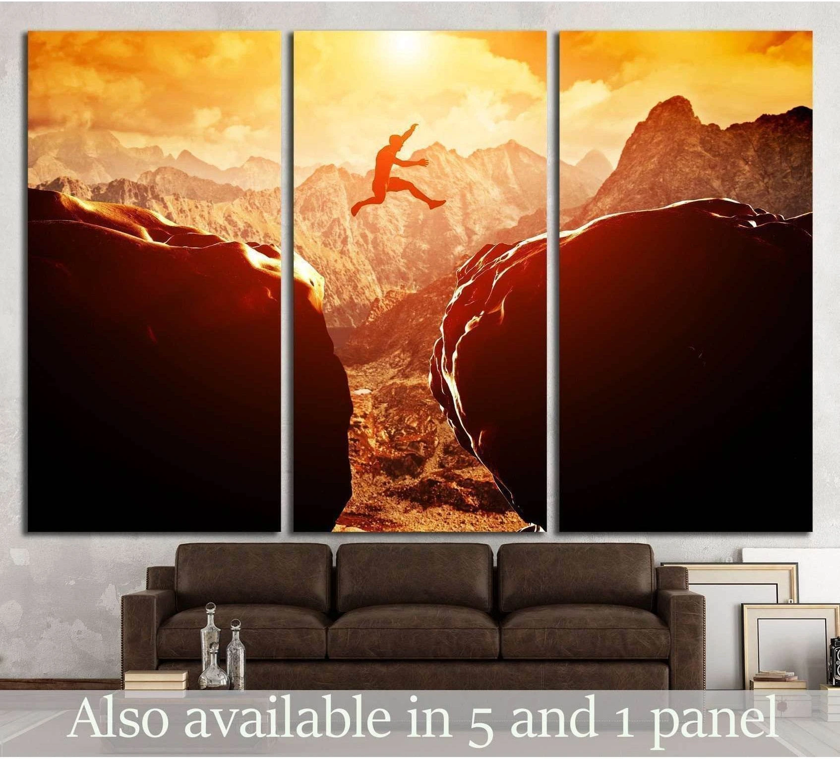 Triptych cliff jumping canvas print with silhouetted man leaping between rocky mountains at sunset