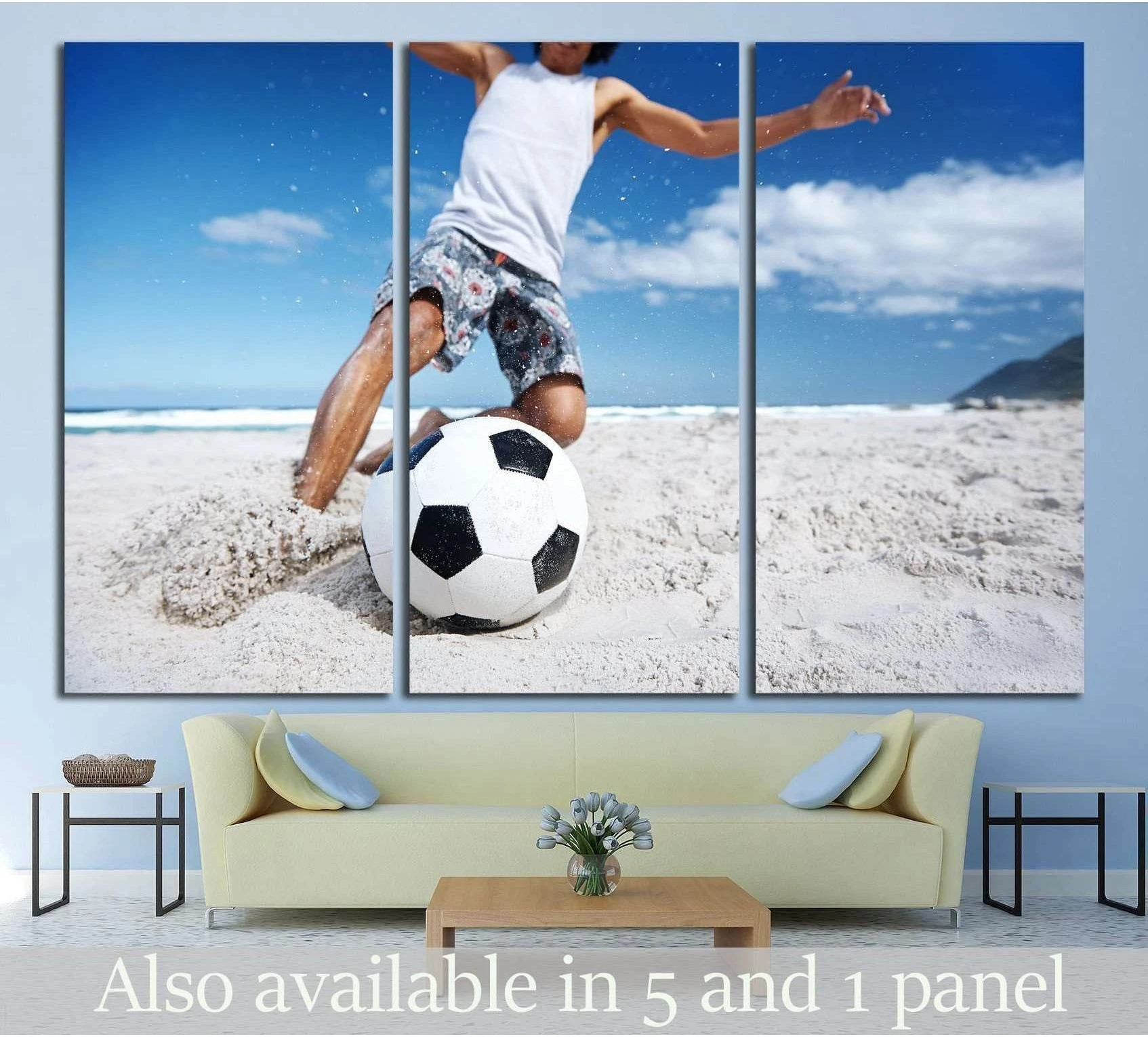 Triptych beach soccer canvas print above sofa with player kicking ball on white sand under blue sky