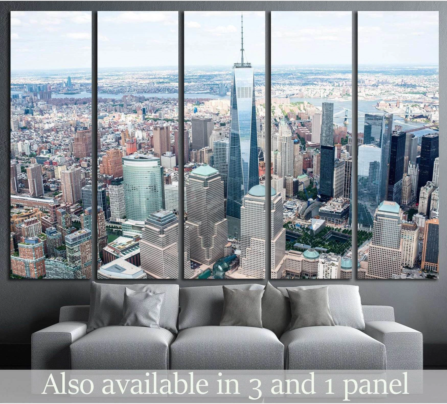 Manhattan aerial canvas print with One World Trade Center hung above a sofa in a modern living room
