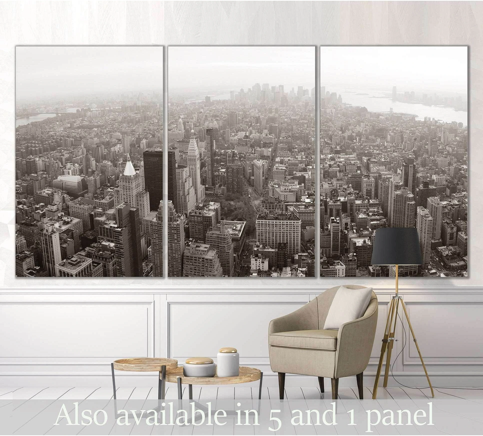 Black and white Manhattan skyline triptych canvas print displayed above a chair in a modern living room