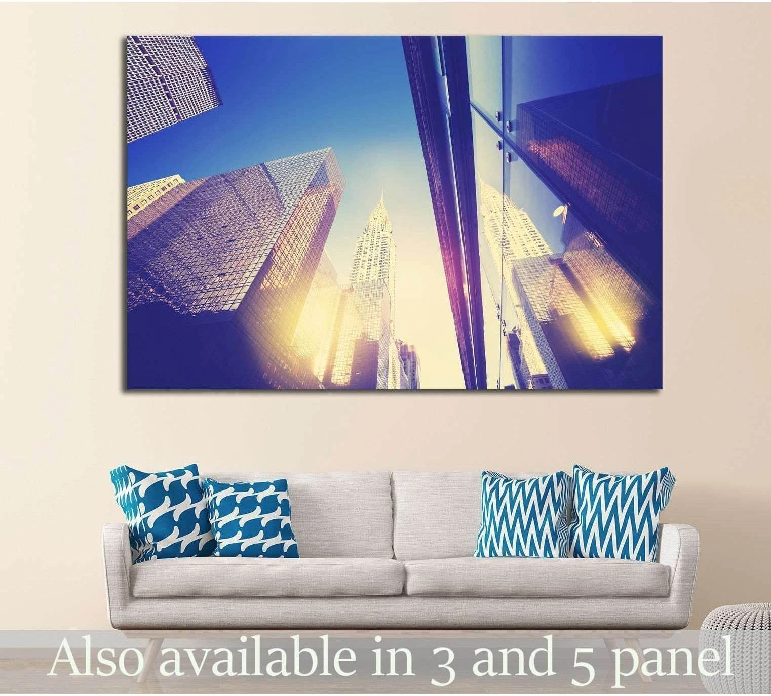 NYC skyscrapers canvas print with mirrored sunset reflections above a sofa in a modern living room