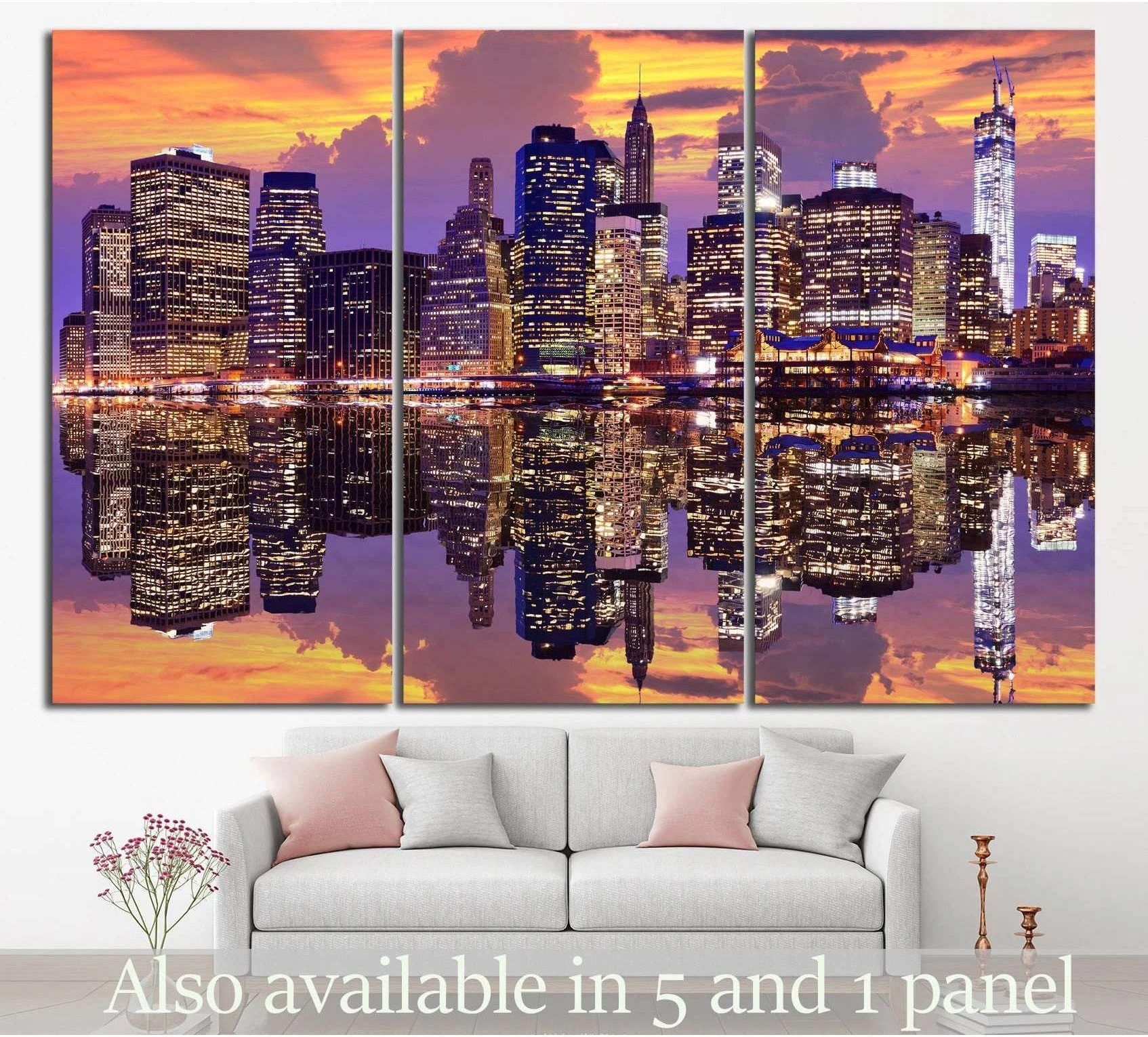 Manhattan skyline triptych canvas print with sunset reflections above sofa in modern living room