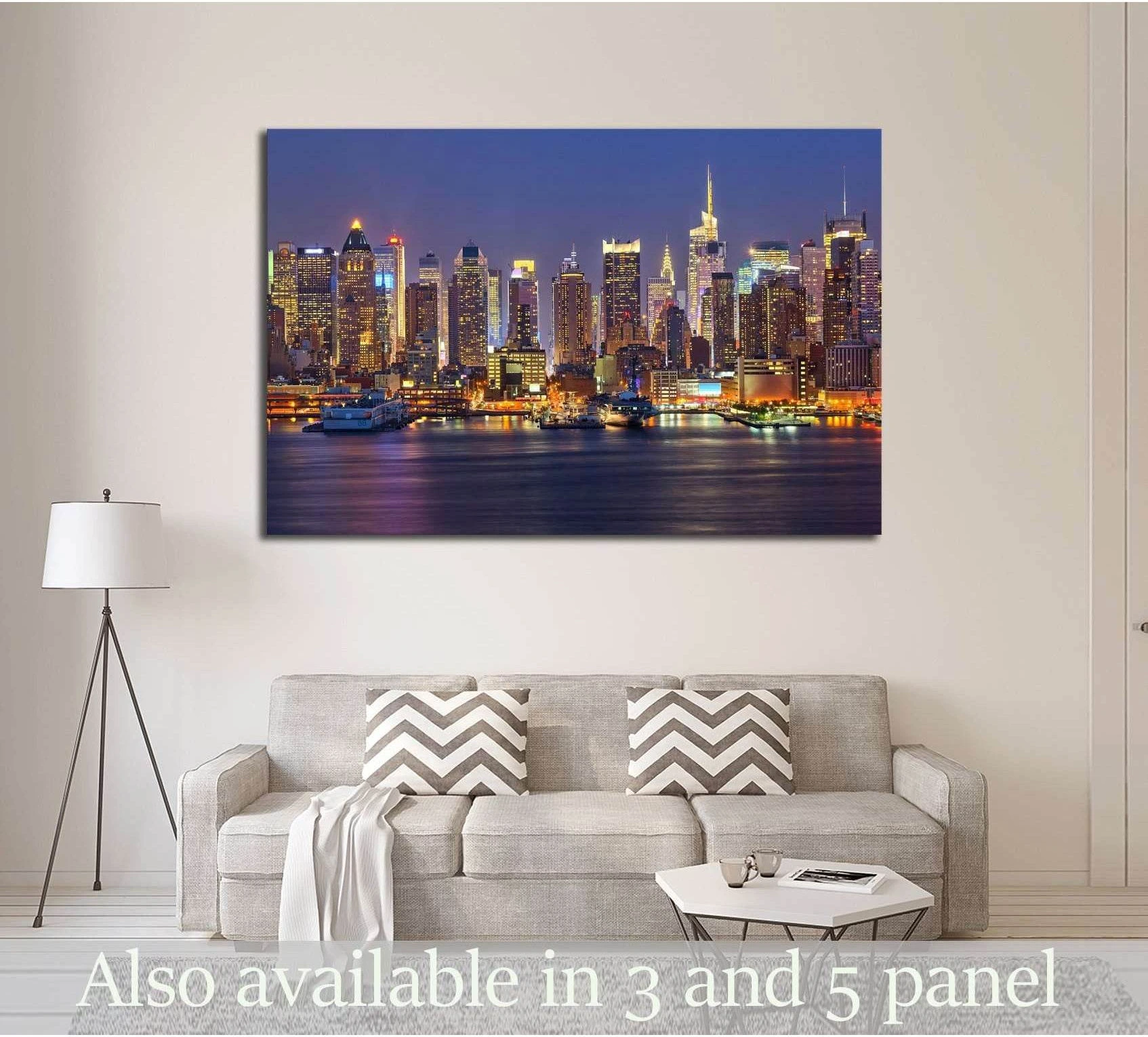New York skyline canvas print above a sofa in a modern living room with glowing city lights