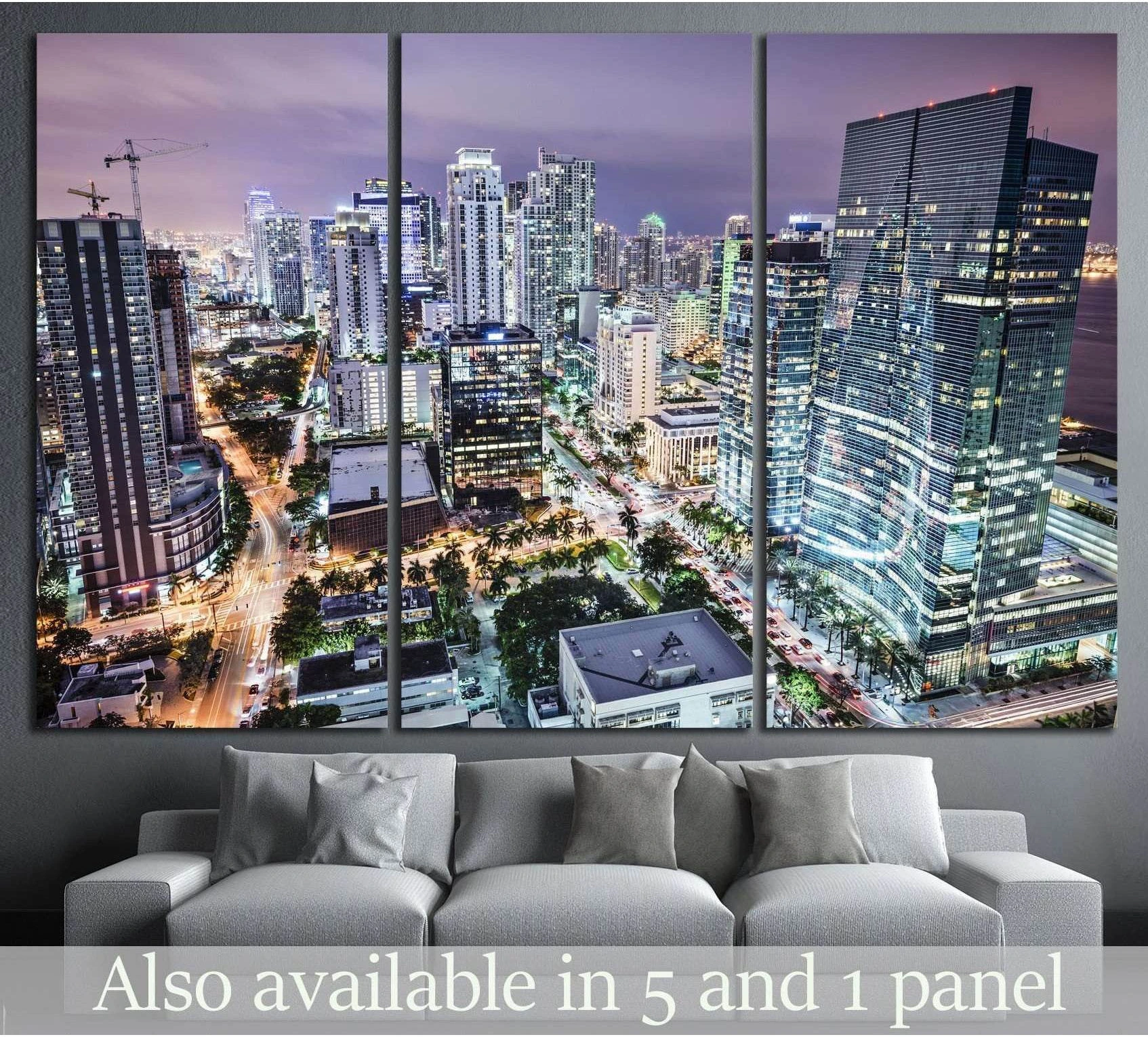 Miami skyline canvas print in a triptych layout above a sofa in a modern living room