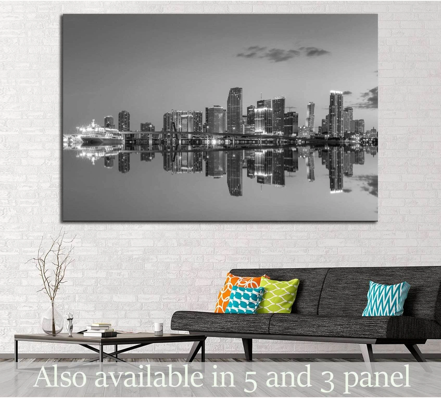 Black and white Miami skyline canvas print with mirrored waterfront above sofa in modern living room