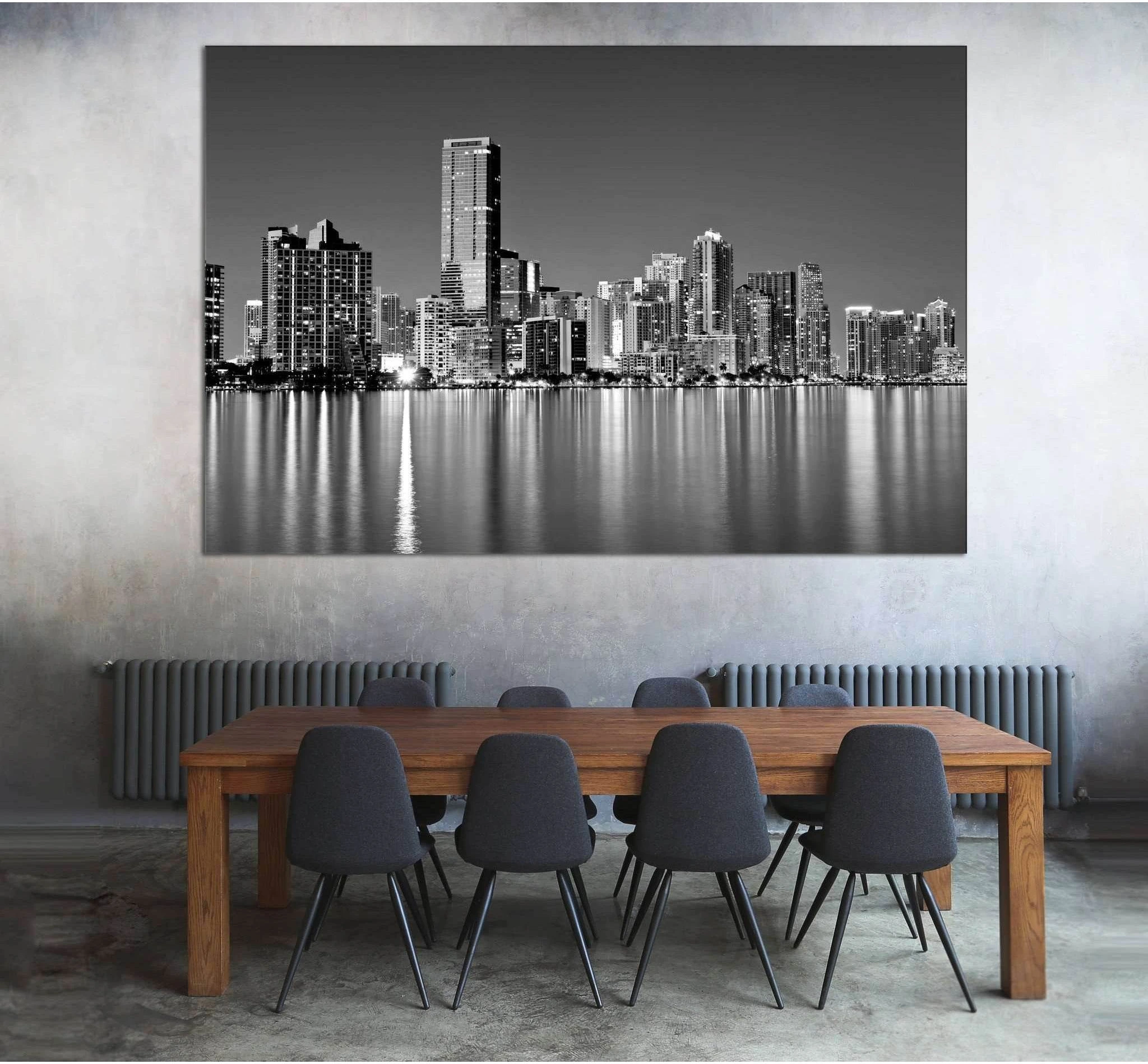 Black and white Miami skyline canvas print above dining table in a modern industrial room