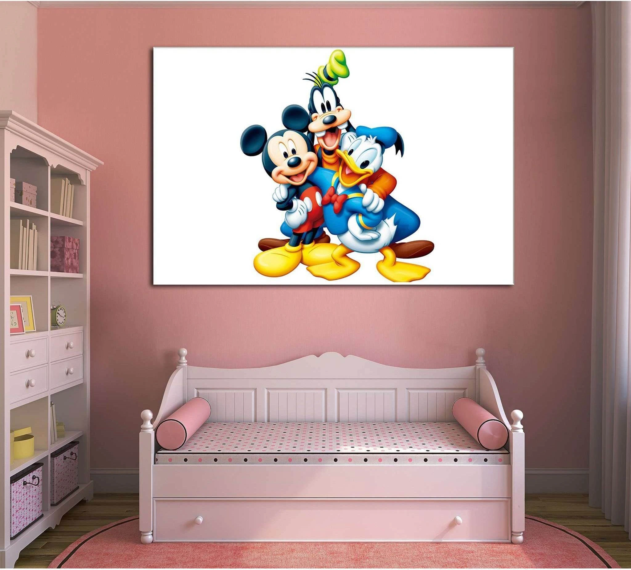 Mickey Mouse, Donald Duck, and Goofy canvas print hung above a pink daybed in a kids room