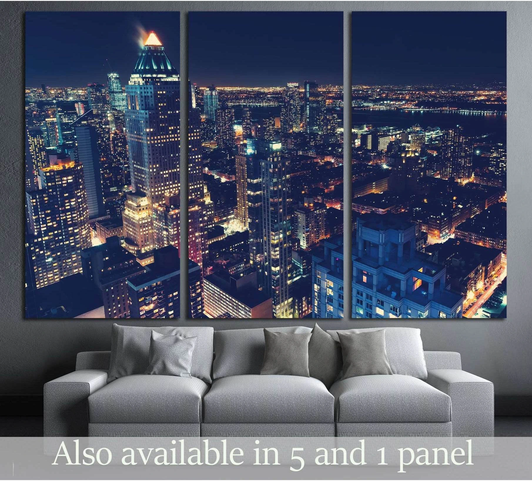 Midtown Manhattan night skyline triptych canvas print above a gray sofa in a modern living room