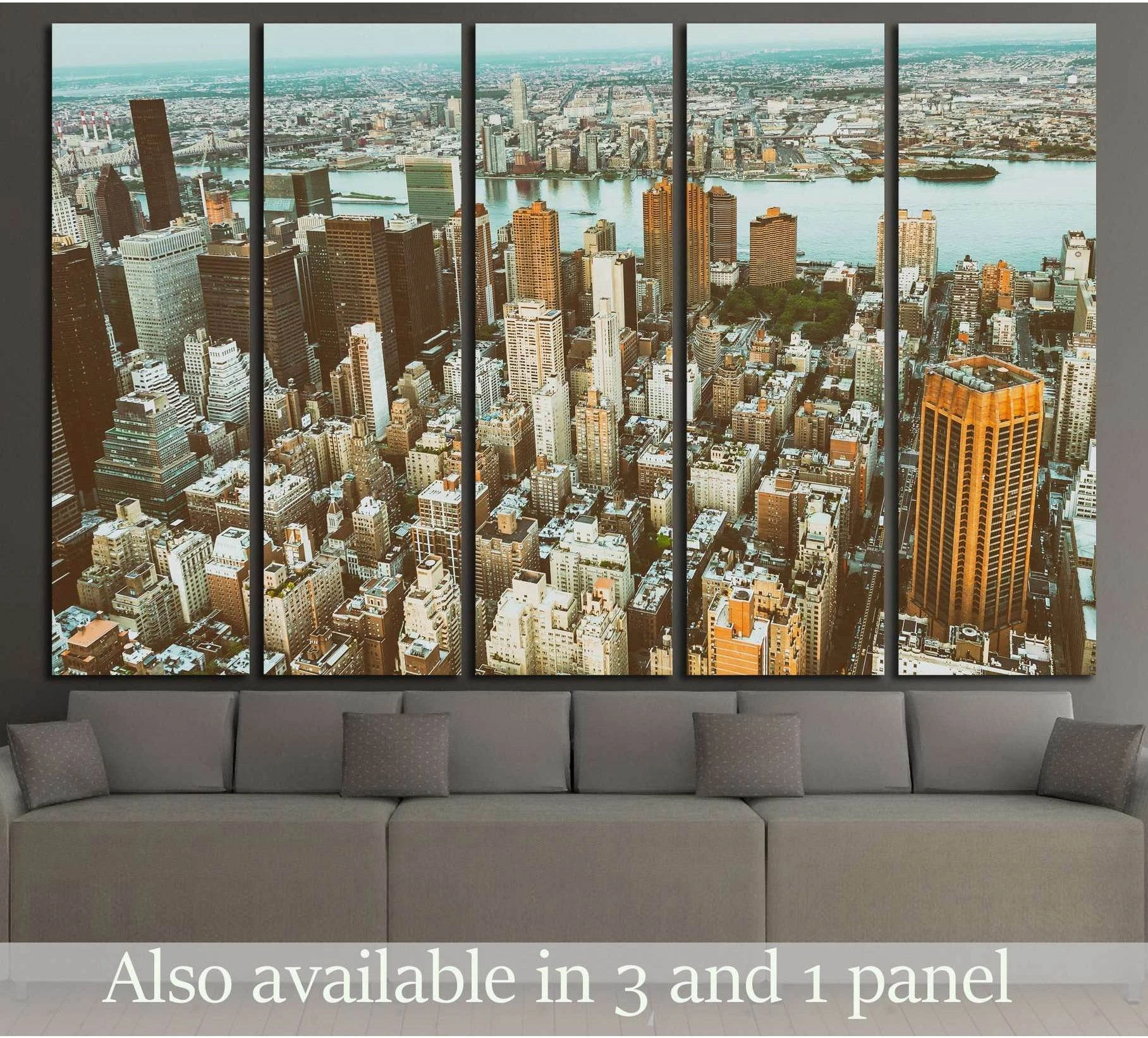 Midtown Manhattan aerial skyline canvas print in warm gold and teal tones above a gray sofa