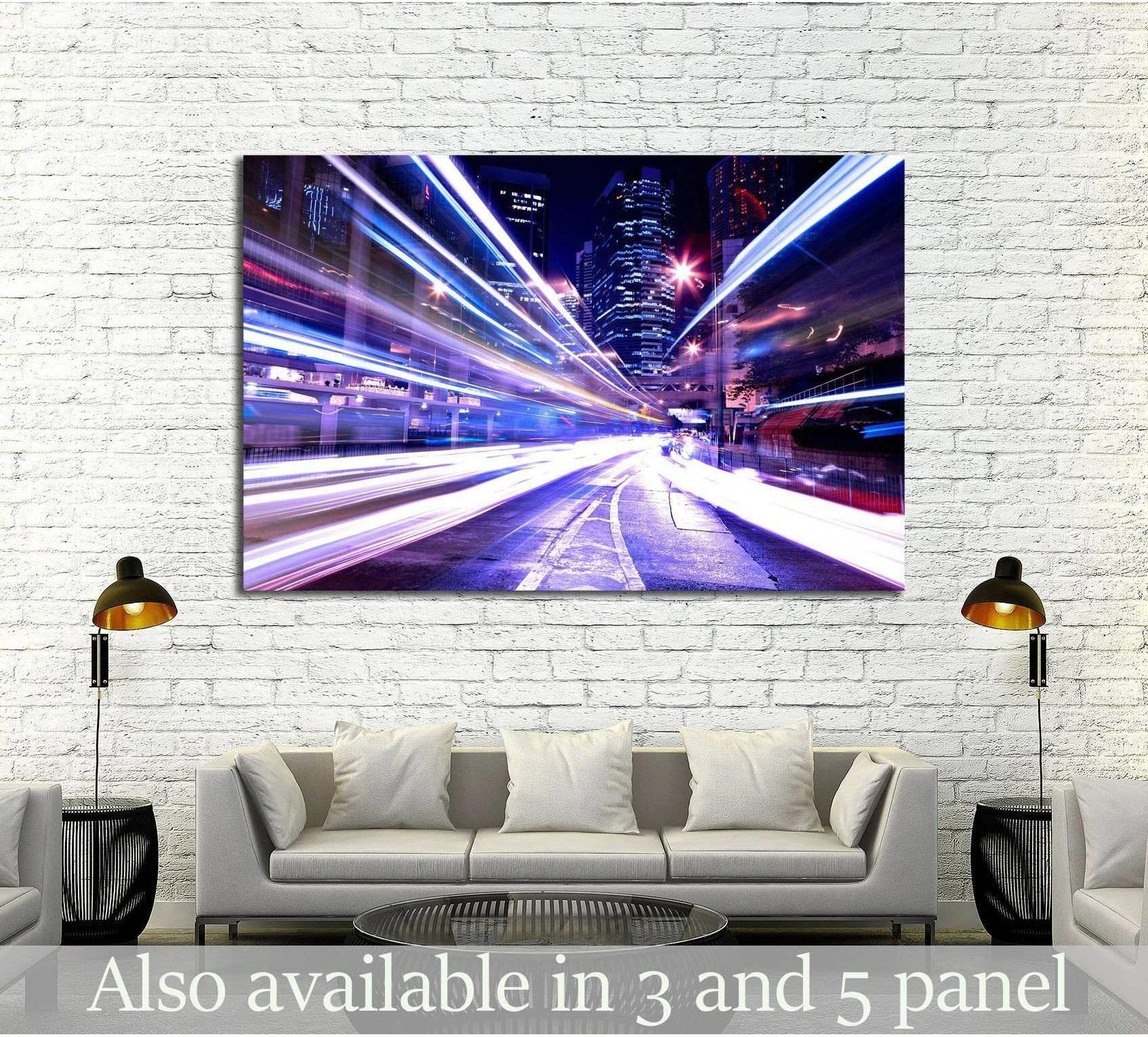 Night city light trails canvas print hung above a sofa in a modern white brick living room