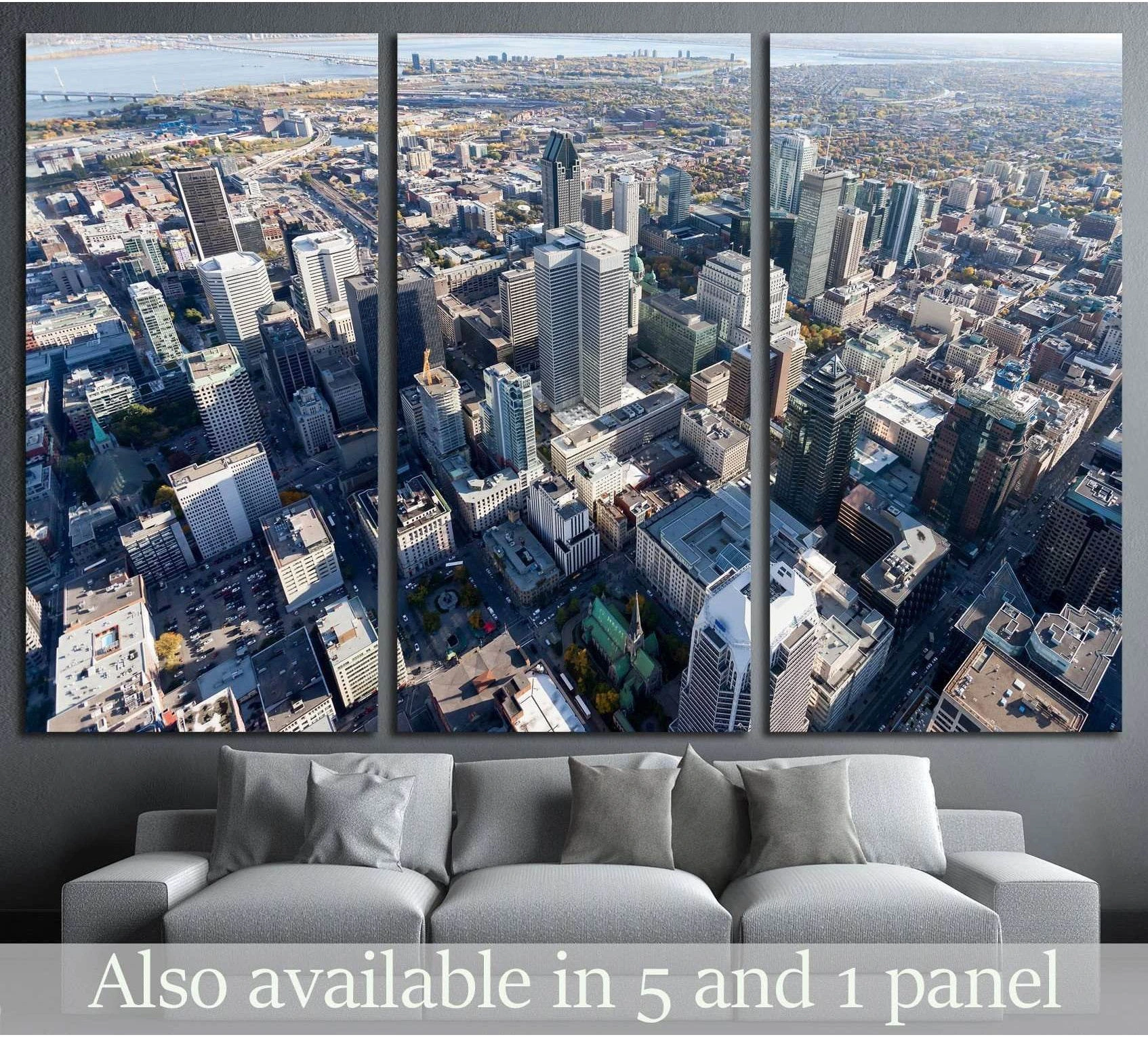 Aerial Montreal skyline triptych canvas print above a gray sofa in a modern living room