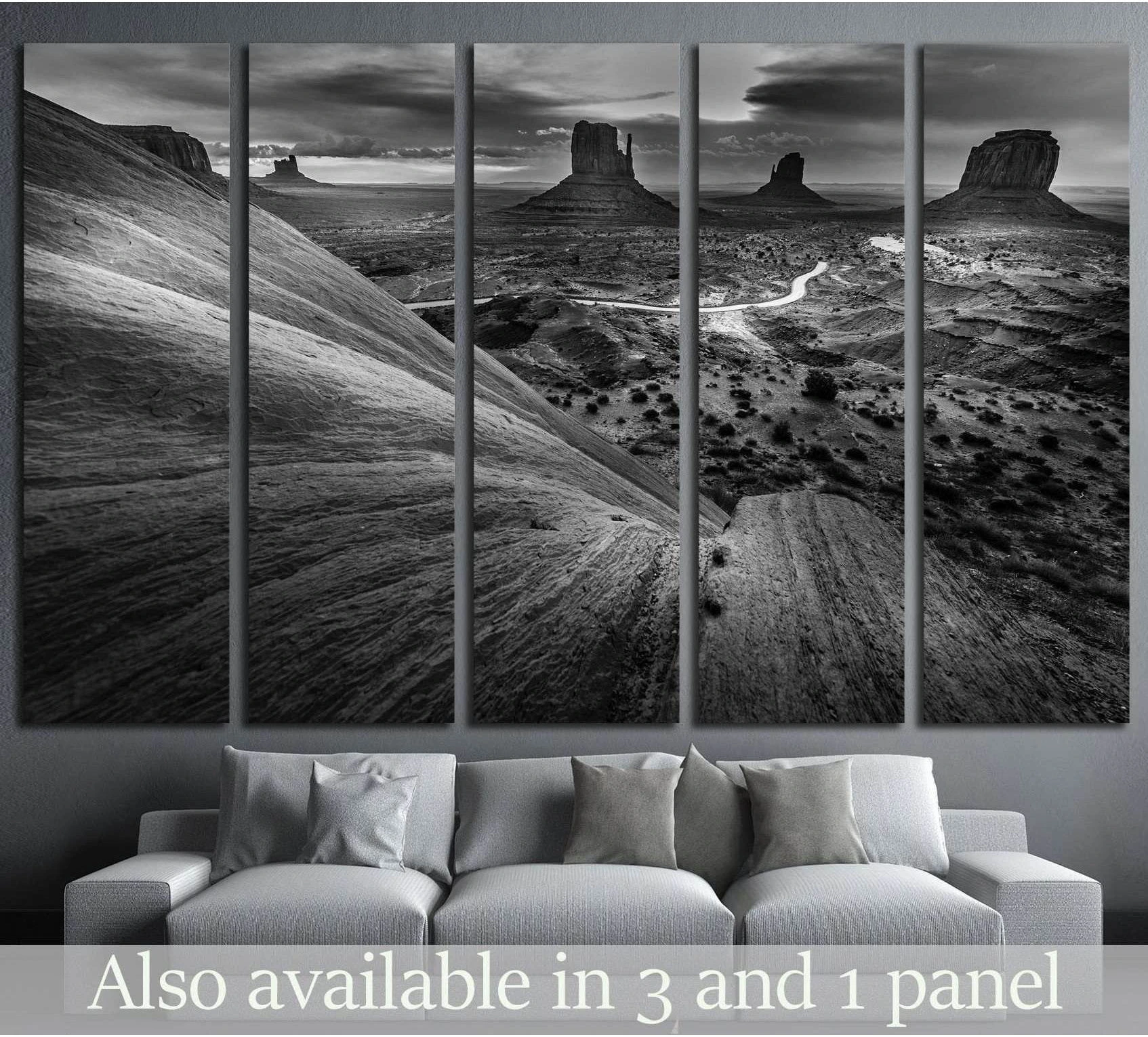 Black and white Monument Valley canvas print in five panels above a sofa in a modern living room