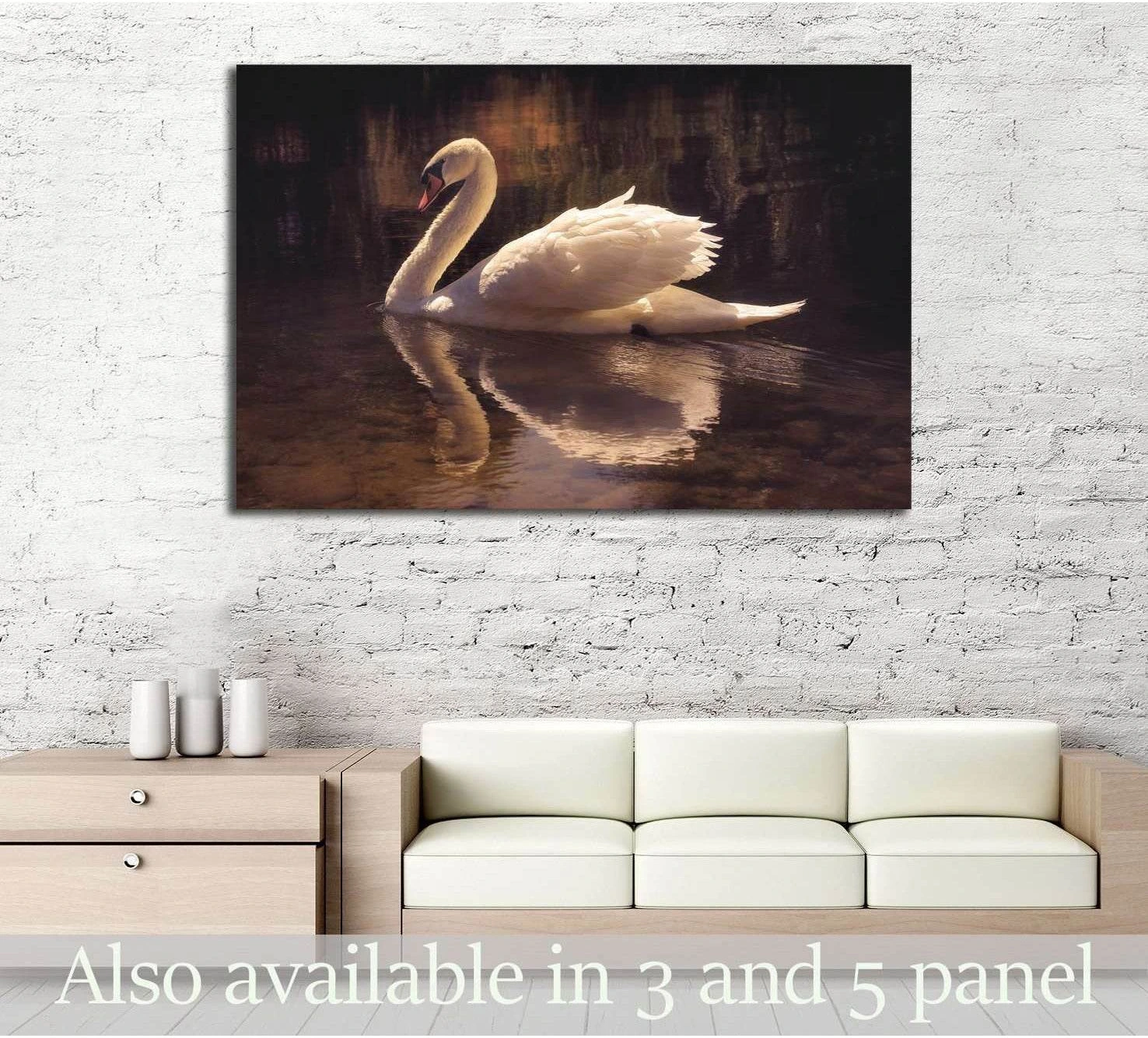 White swan canvas print gliding on dark sepia water, displayed above sofa in a neutral living room