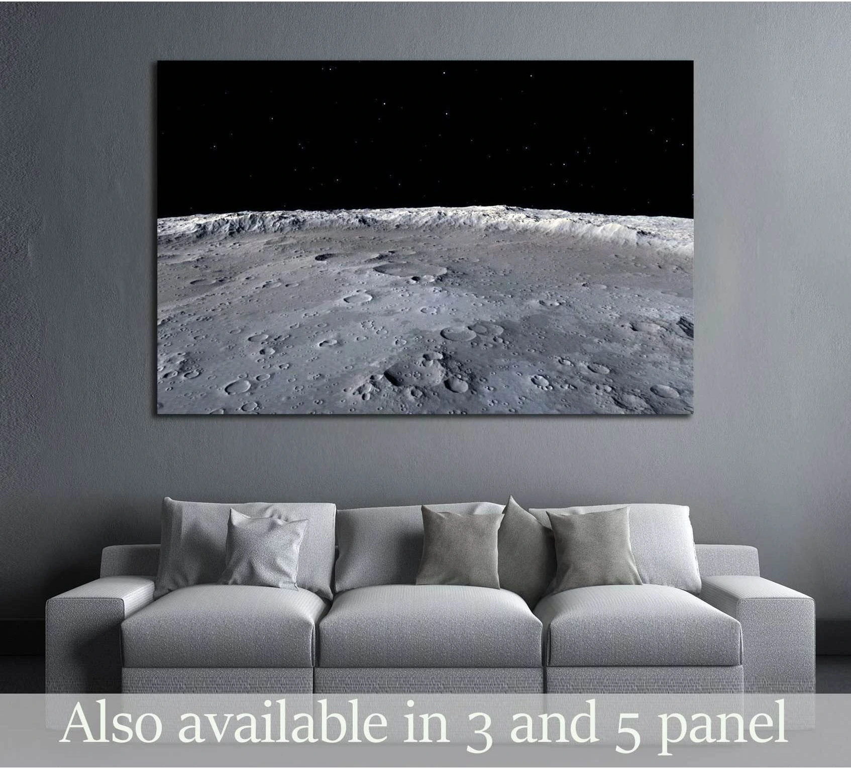 Moon surface canvas print with detailed lunar craters above a sofa in a modern grey living room