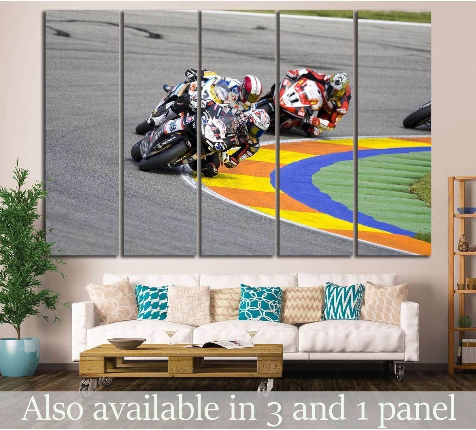 MotoGP riders canvas print above a sofa, showing racers leaning through a bright track corner