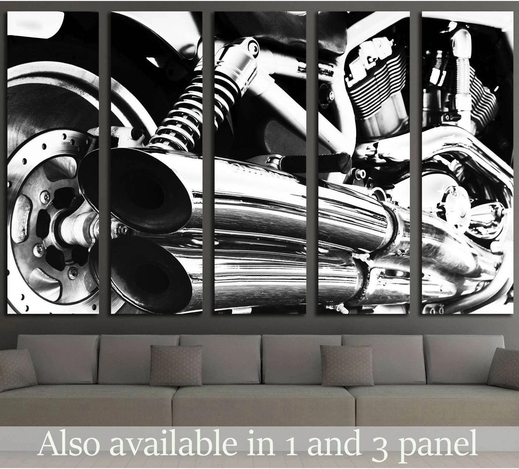 Black and white motorcycle engine canvas print with chrome exhaust, displayed above a sofa in a modern living room