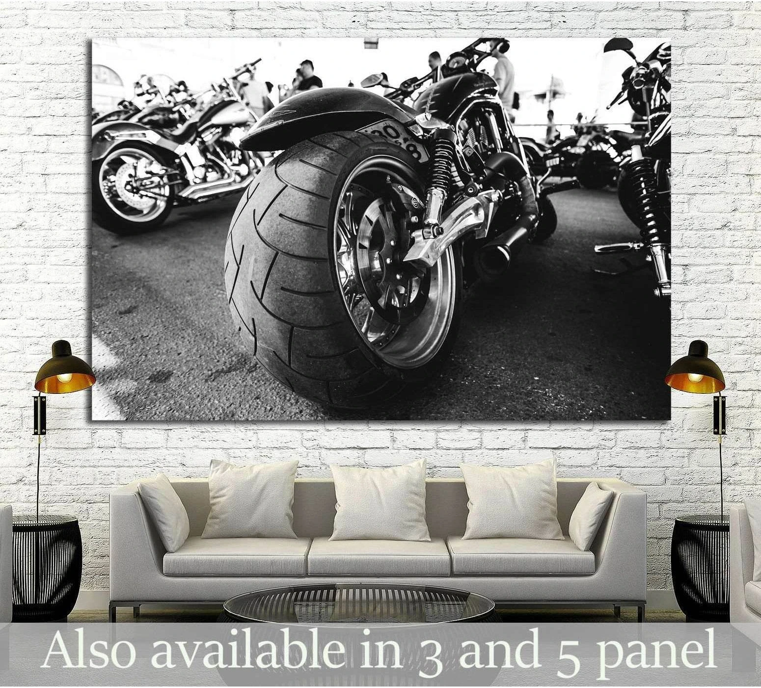 Black and white motorcycle canvas print with close-up rear wheel above a sofa in a modern living room