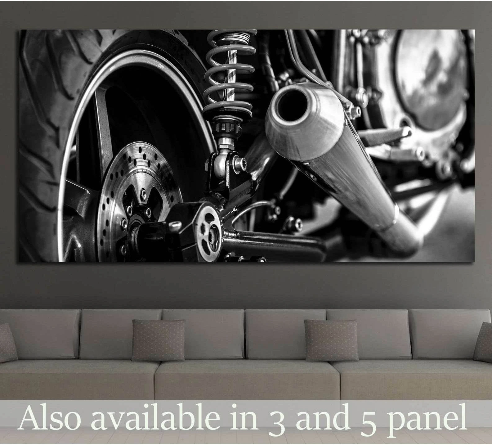 Black and white motorcycle rear wheel and exhaust canvas print above sofa in modern room
