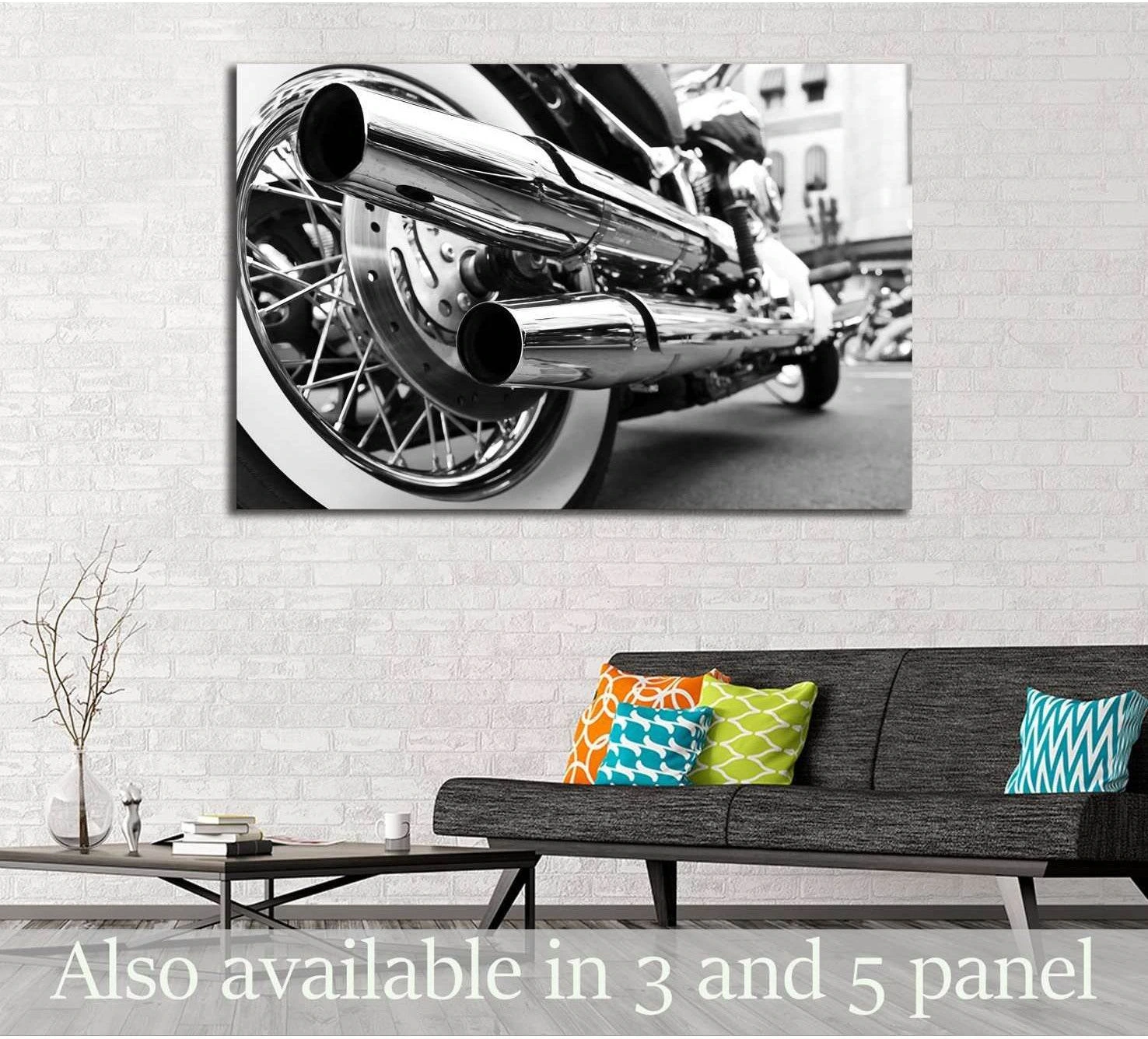 Black and white motorcycle exhaust canvas print with chrome pipes above a sofa in a modern living room