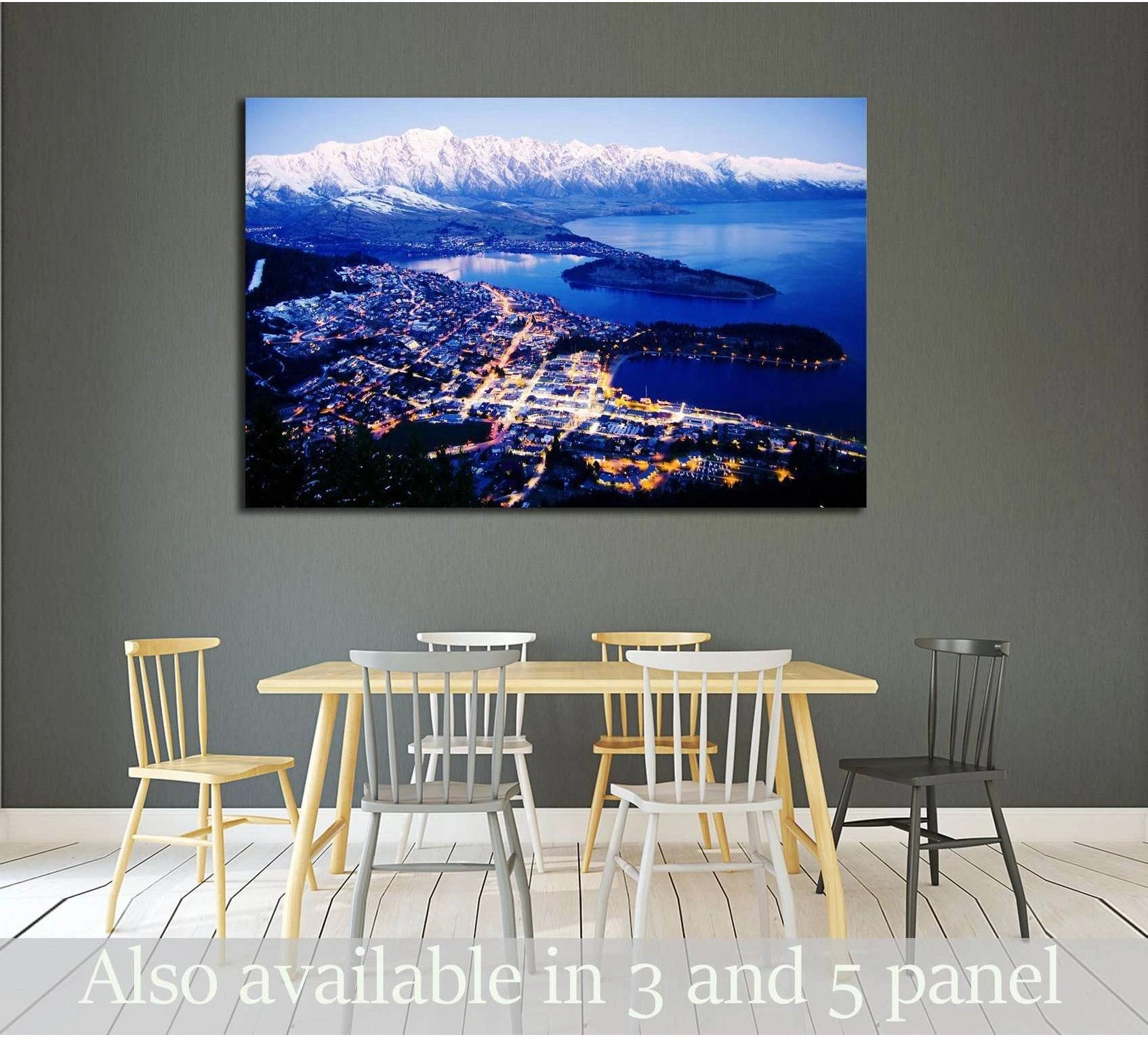 Snowy alpine lake town canvas print with glowing night lights above a dining room table