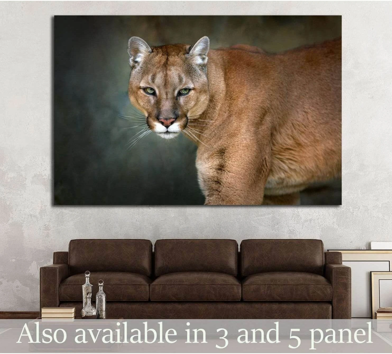Mountain lion canvas print with close-up cougar portrait on dark background above sofa in modern living room