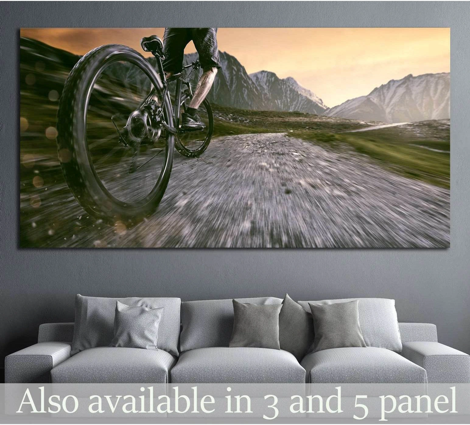 Mountain biker canvas print with cyclist riding uphill on an alpine gravel trail at sunset above a sofa