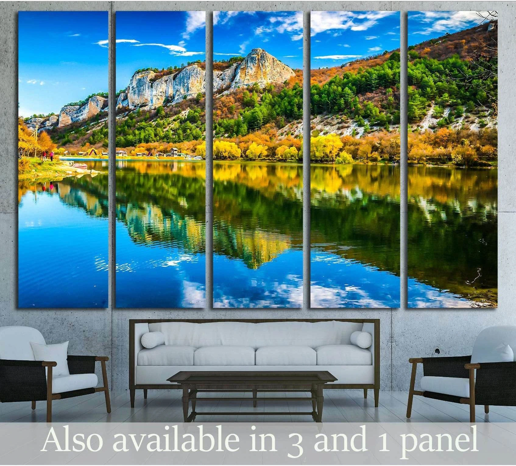 Mountain lake canvas print with autumn trees, rocky cliffs, and mirrored water above a sofa