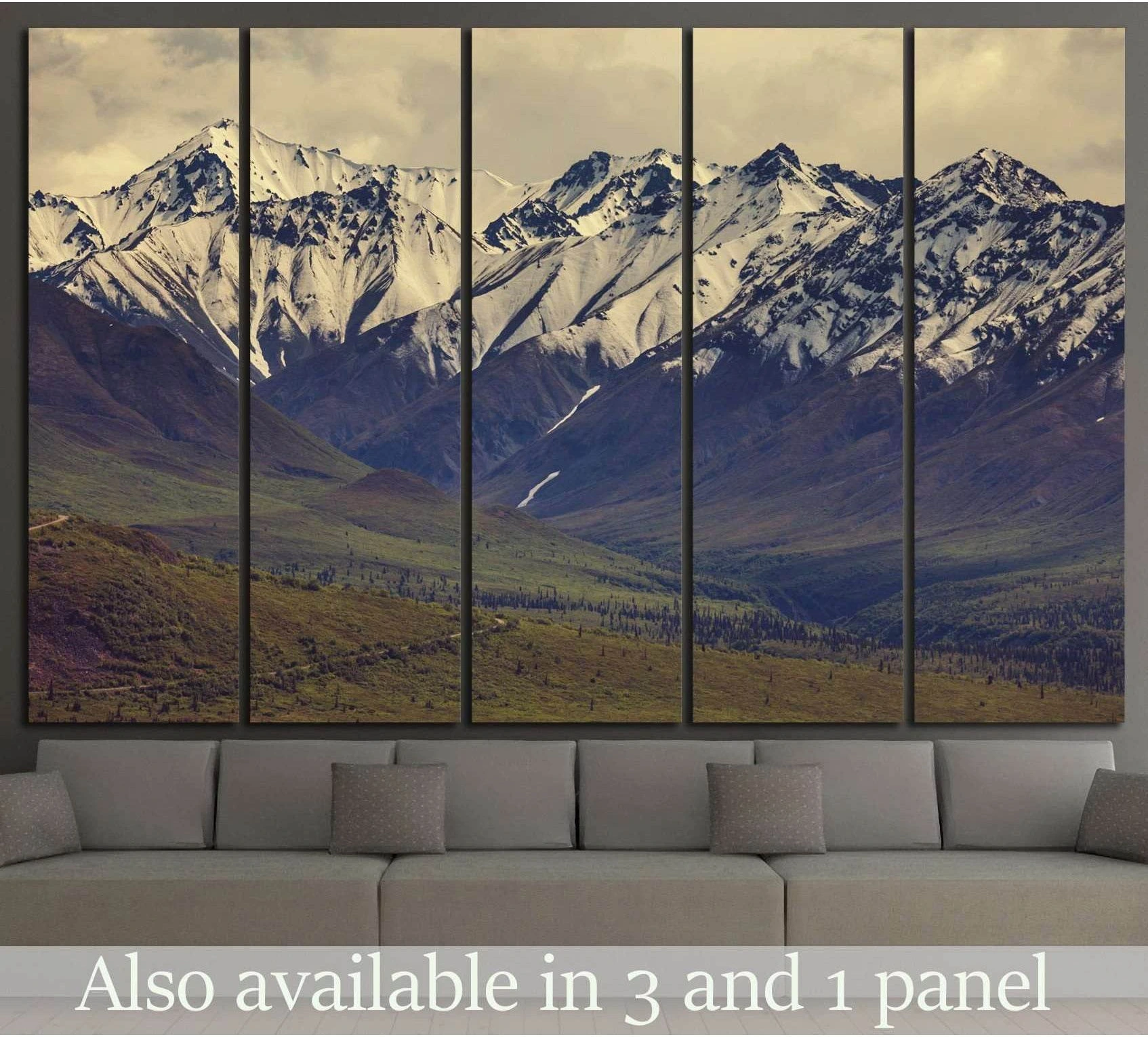 Snow-capped Alaska mountains panoramic canvas print hung above a sofa in a modern living room