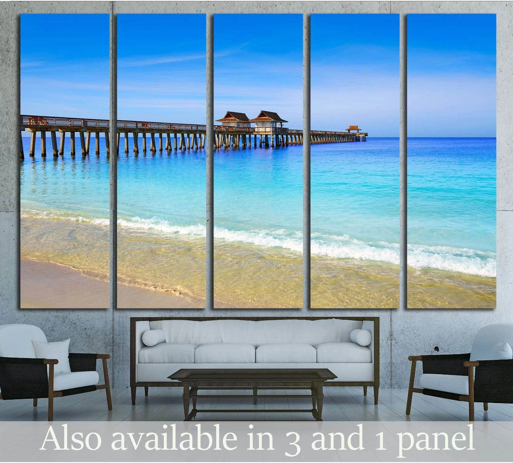 Naples Pier and beach in florida USA sunny day showing sea water, shoreline and horizon depth.