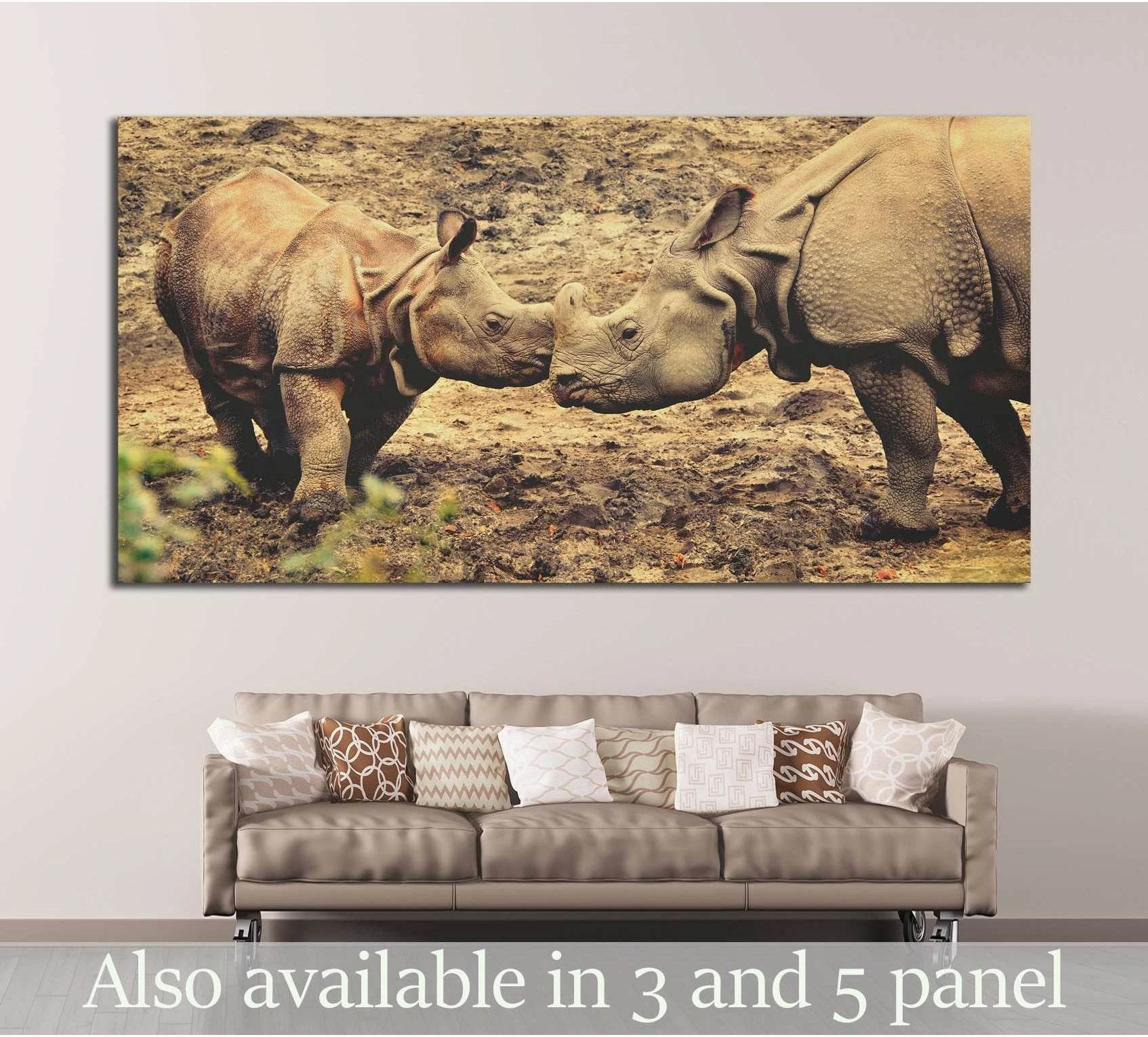 Rhino canvas print above sofa featuring two rhinoceroses touching nose to nose in warm earthy tones
