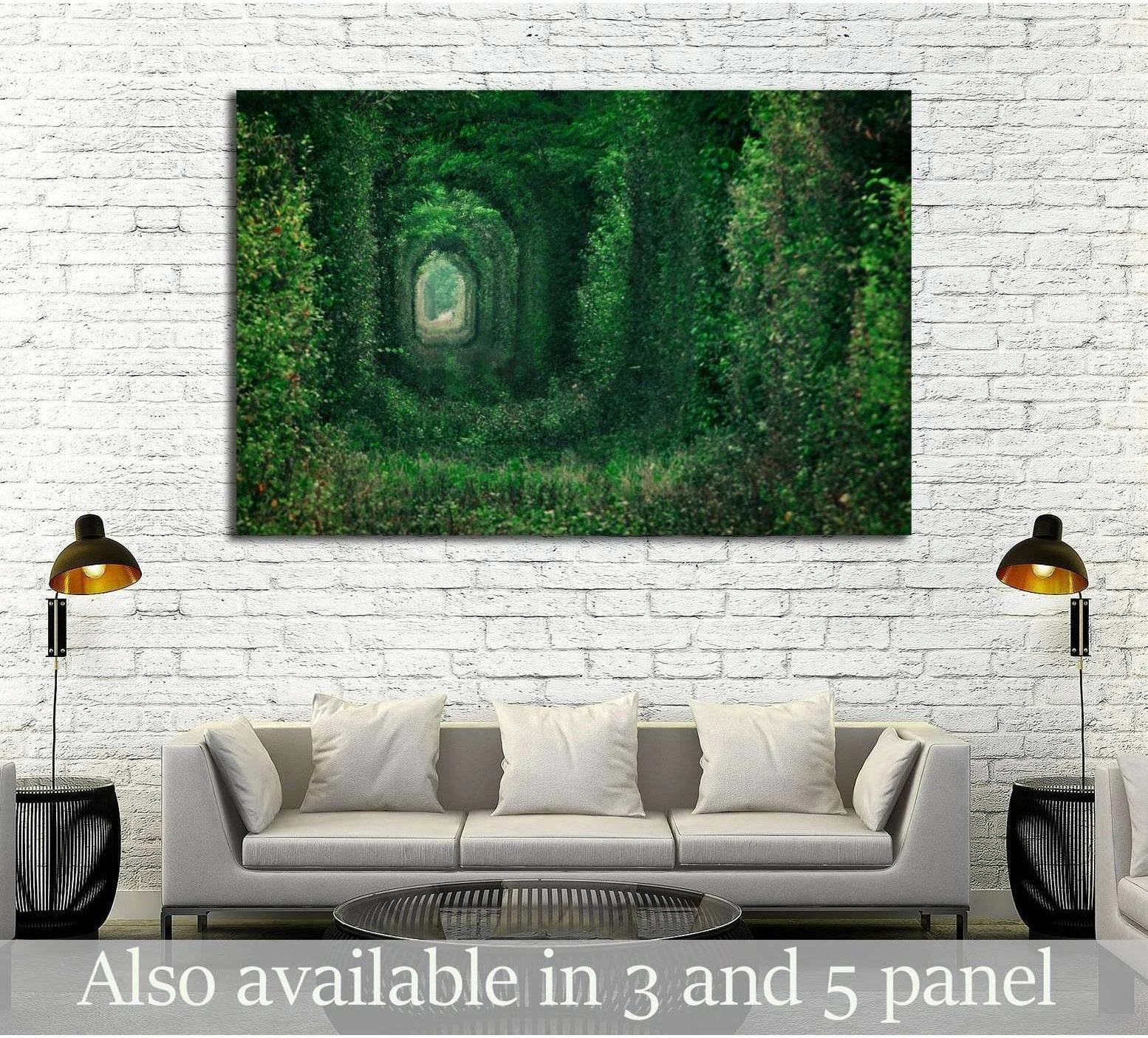 Green tree tunnel canvas print above sofa in a modern living room with white brick wall
