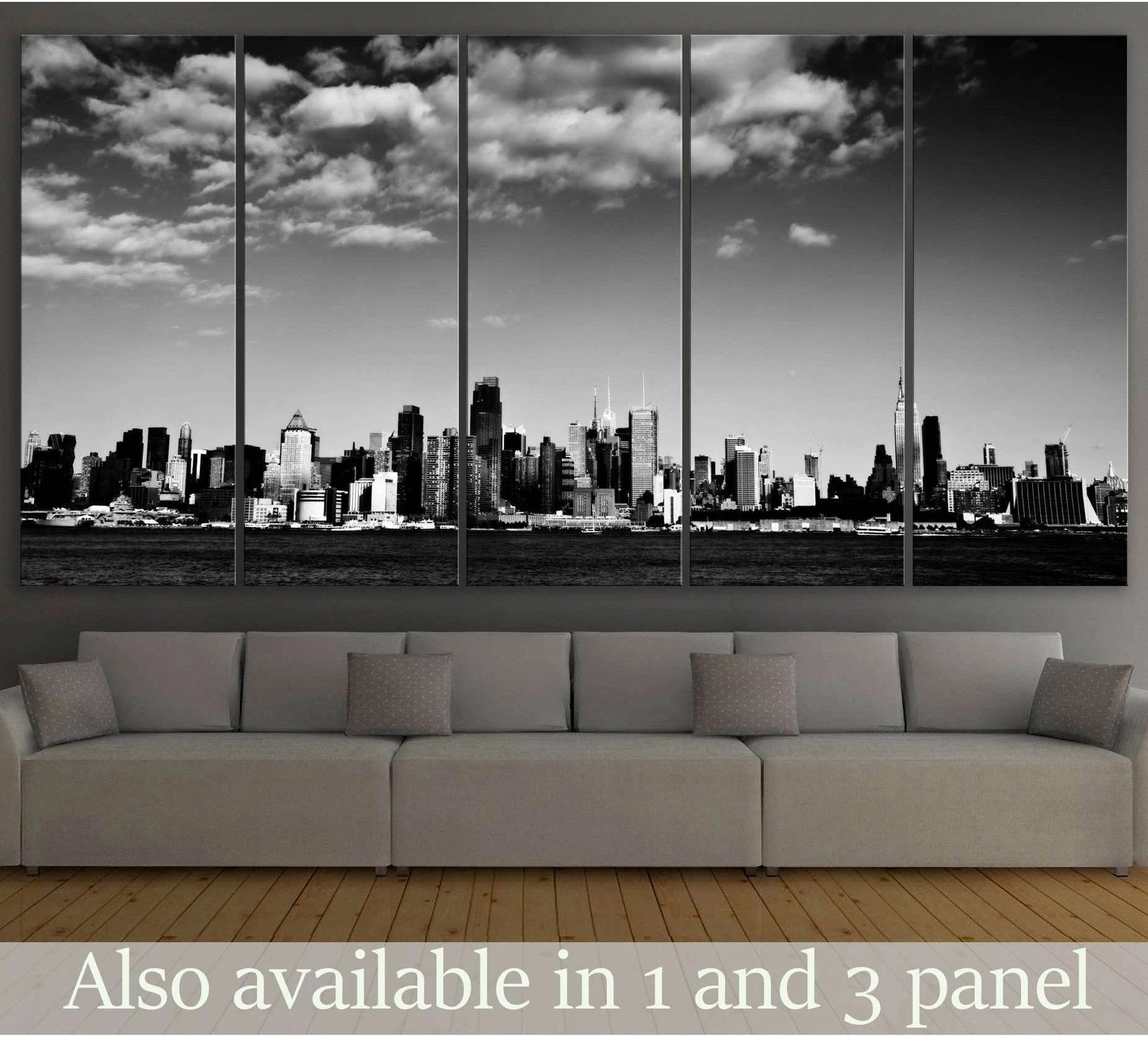 Black and white NYC skyline canvas print above sofa in a modern living room