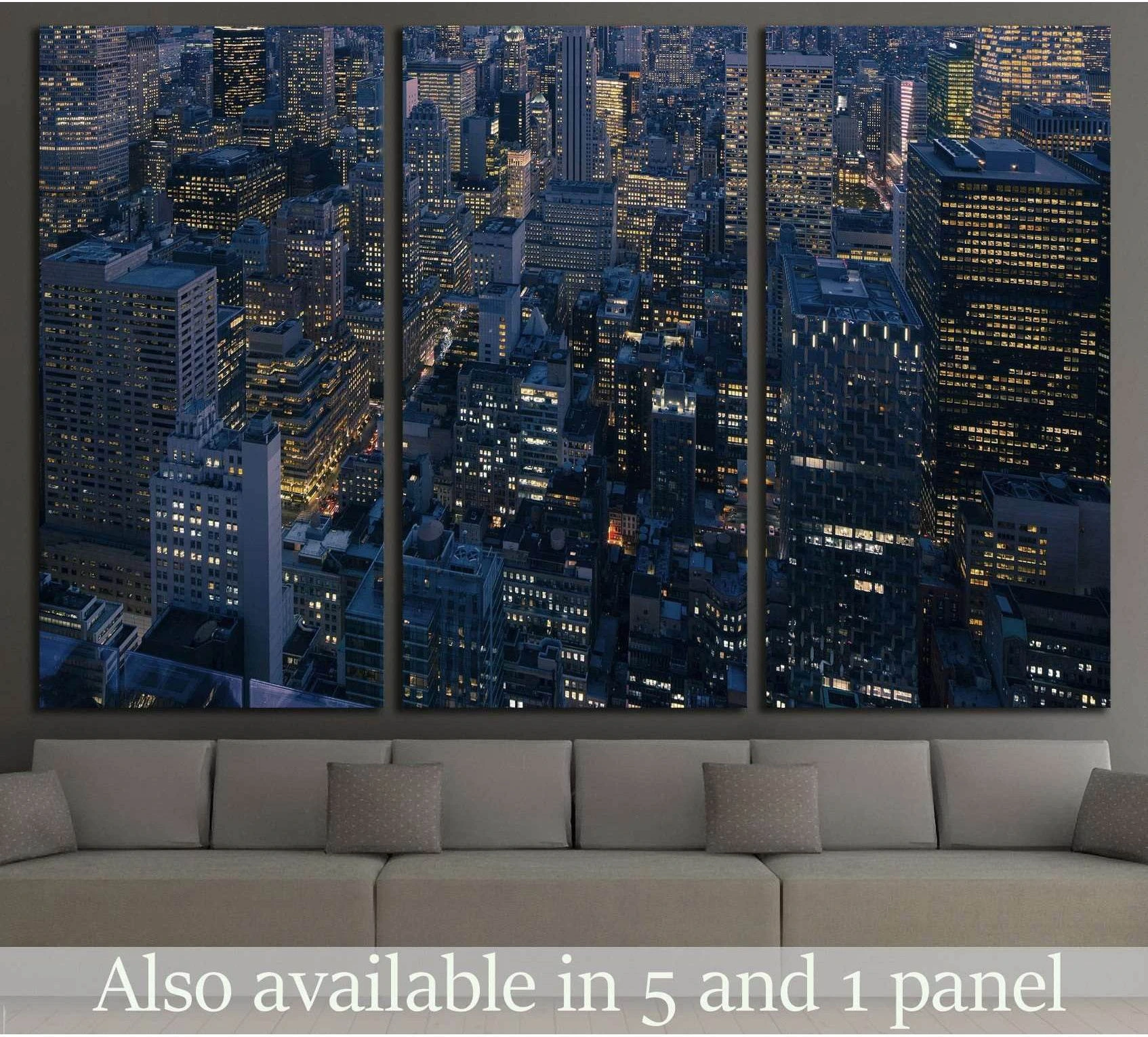 NYC night skyline triptych canvas print with aerial Manhattan towers above a sofa