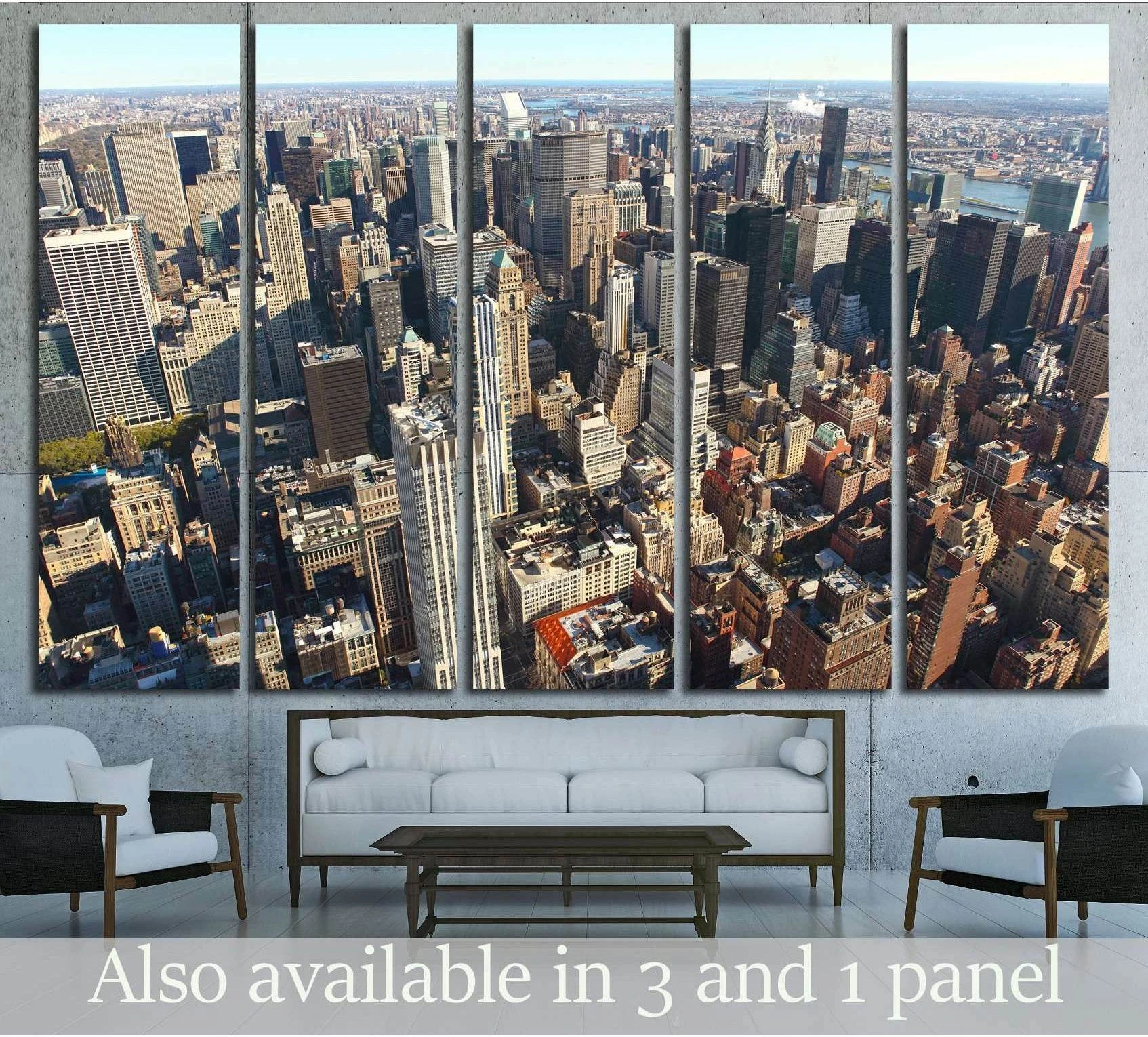Aerial Manhattan skyline canvas print in a five-panel layout above a sofa in a modern living room