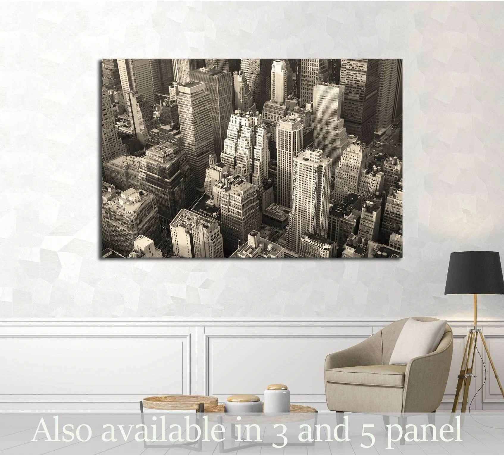 Black and white Manhattan skyline aerial view canvas print displayed above a chair in a modern living room