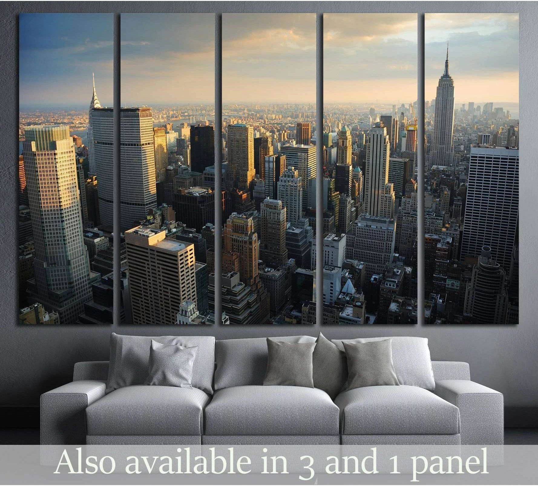 Manhattan skyline canvas print with Empire State Building at golden hour above a gray sofa in a modern living room