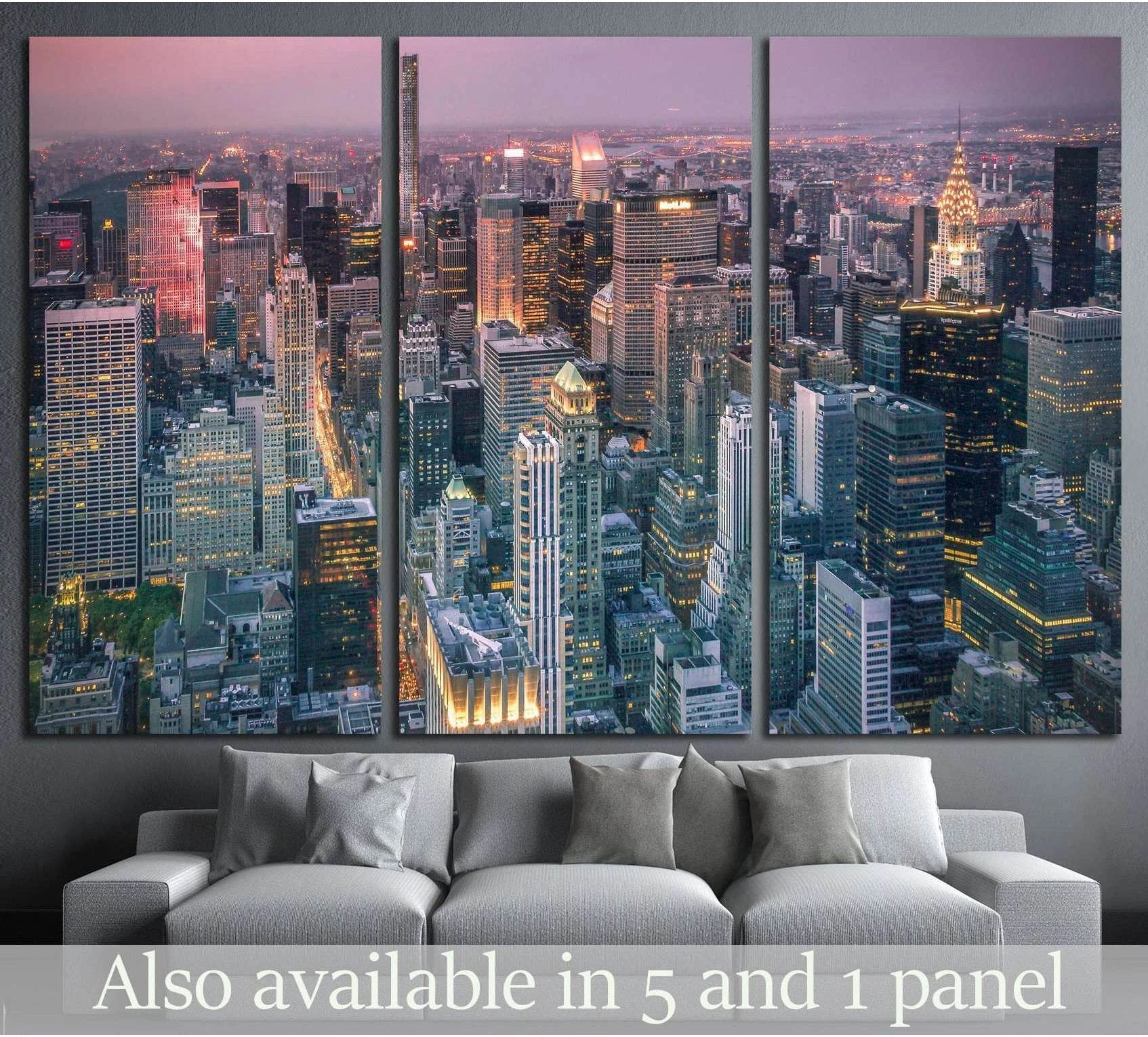 New York City skyline canvas print at dusk above a sofa with Manhattan skyscrapers and the Chrysler Building